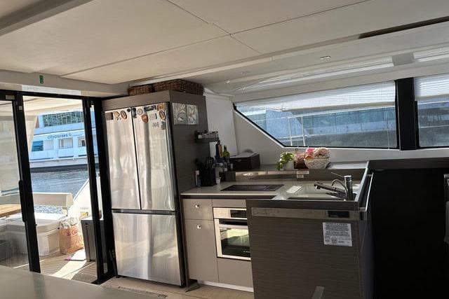 Modern kitchen interior of 2023 Leopard 46 PC yacht with stainless steel appliances.