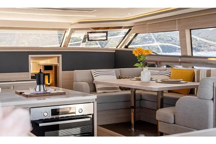 Manufacturer Provided Image: Luxurious interior of 2025 Aquila 46 Yacht with modern kitchen and cozy seating area.