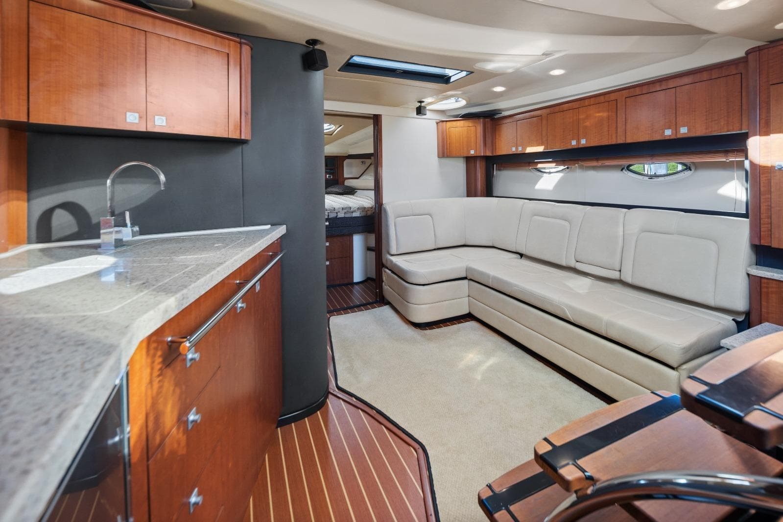 Luxurious interior of 2012 Monterey 400 Sport Yacht with modern kitchen and seating area.