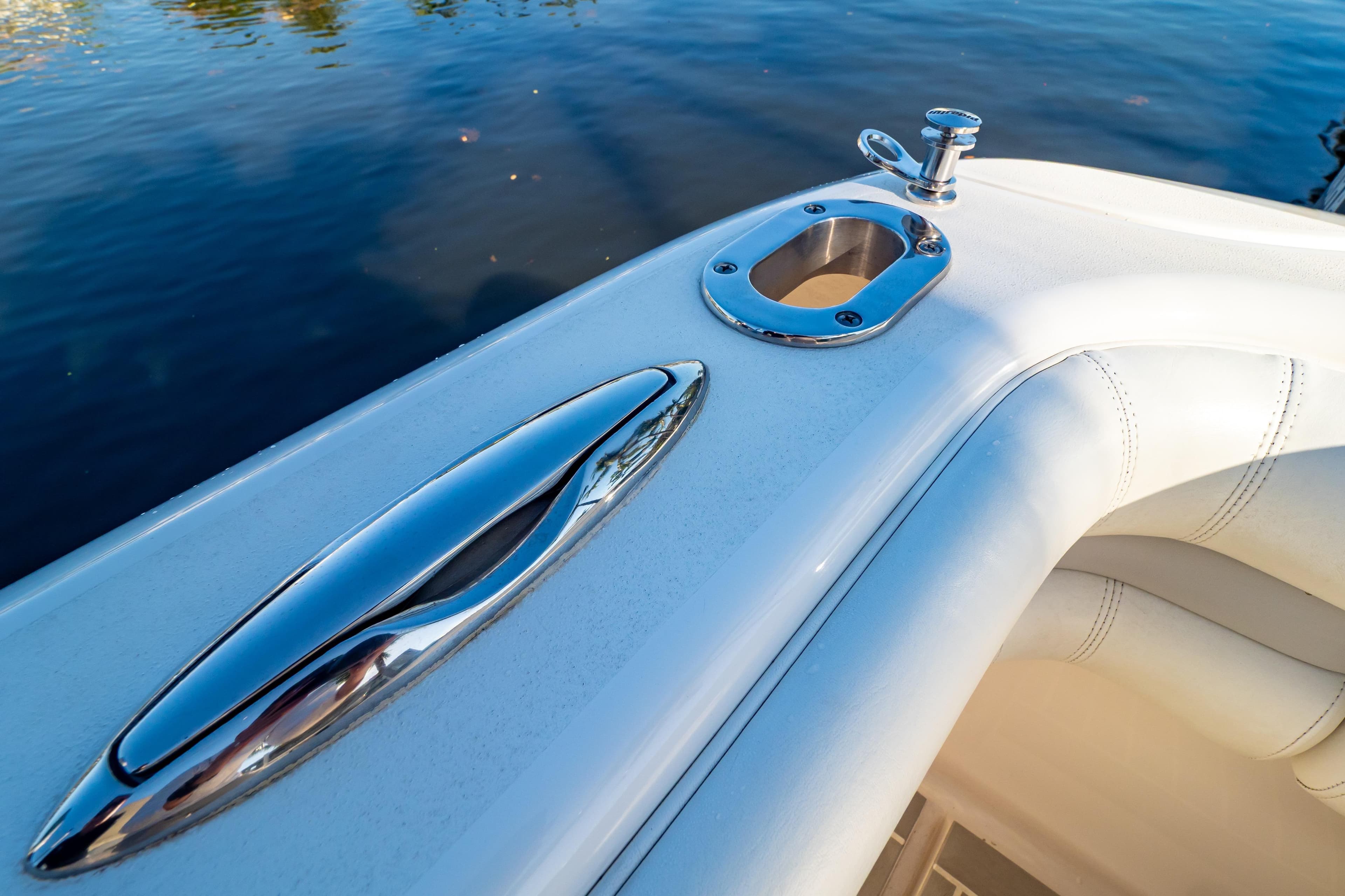 Close-up of 2016 Intrepid 400 Cuddy boat's sleek chrome fittings and white upholstery.