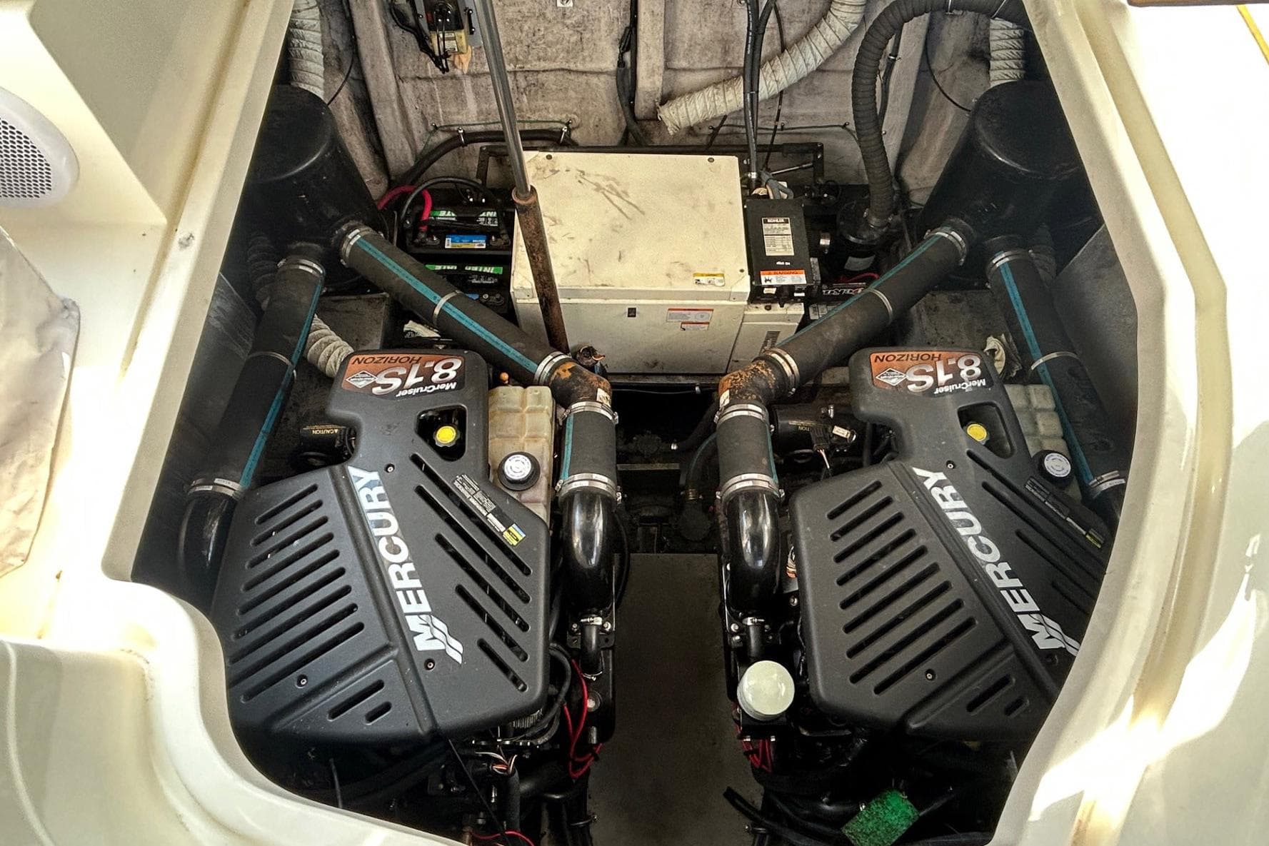 Engine compartment of a 2001 Wellcraft 3700 Martinique with dual Mercury engines.