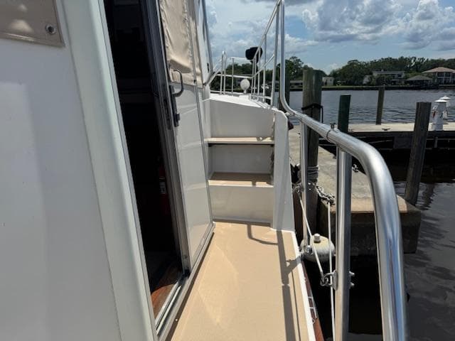 Cherubini 50 Independence 1998 yacht deck with railing and steps at a marina.