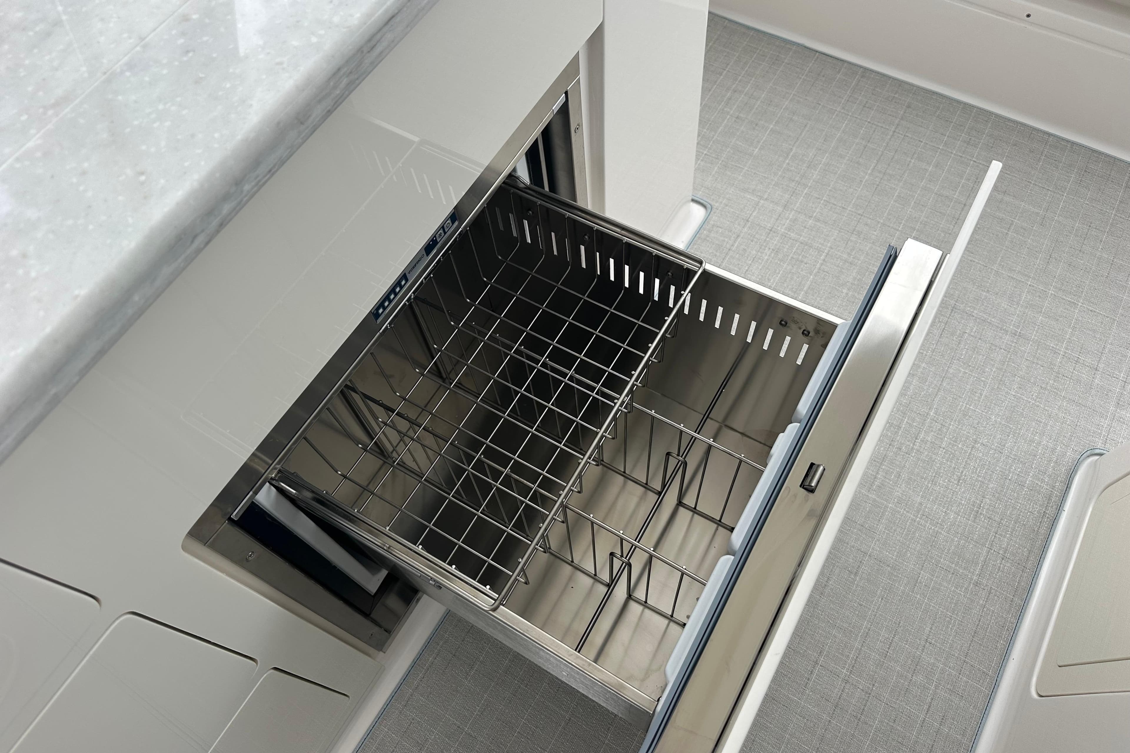 Open drawer with metal basket in 2026 Regal 38 SAV boat interior.