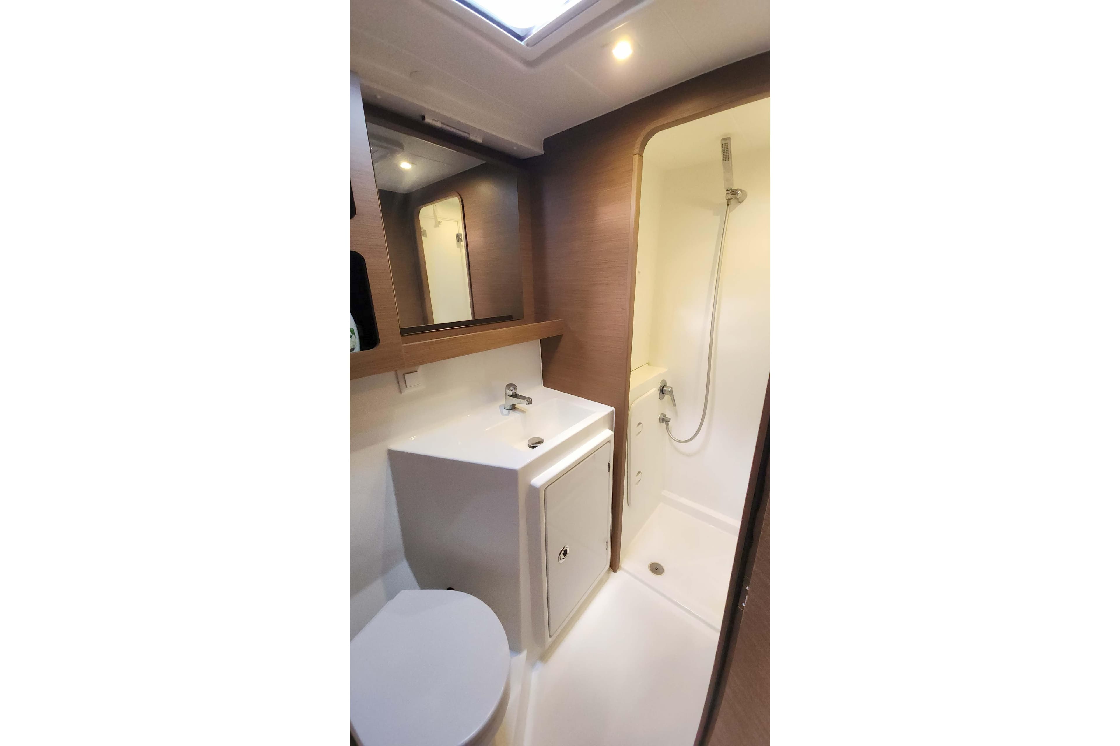 Modern bathroom in 2020 Lagoon 42 yacht with shower and sink.