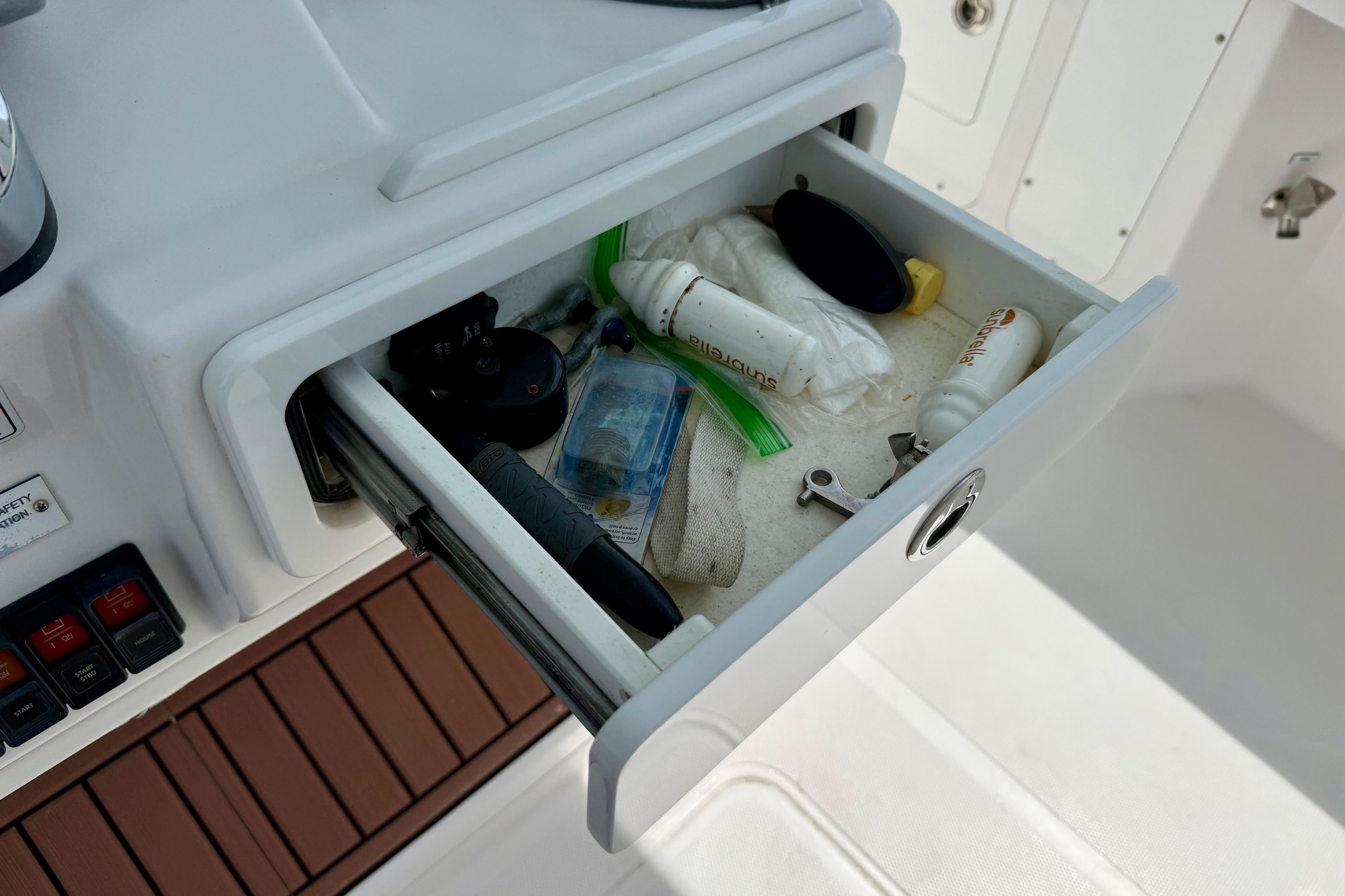Open drawer on 2017 Southport 33 FE boat, containing various small items and tools.