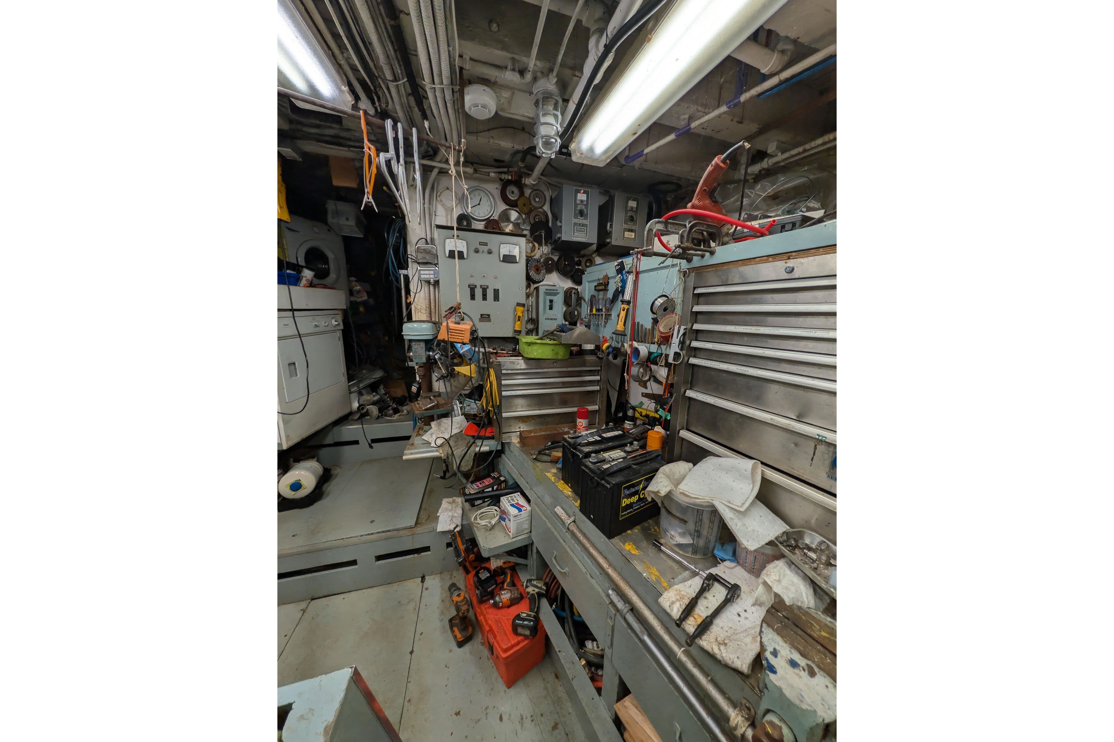 Engine room of 1941 Armstrong Marine Custom Wooden Trawler, featuring tools and equipment.