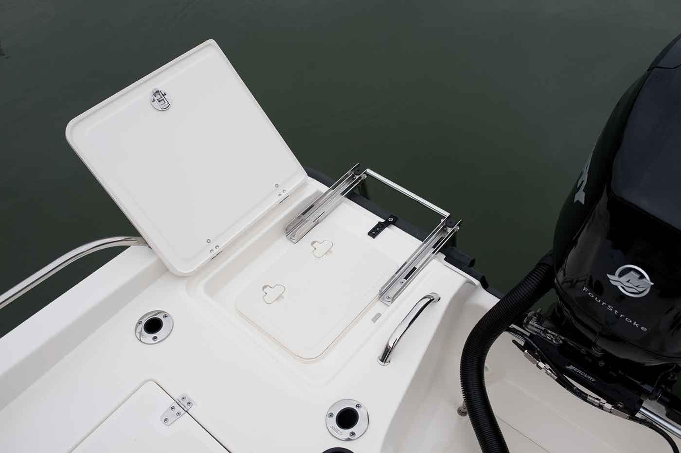 Manufacturer Provided Image: 2021 Boston Whaler 180 Dauntless boat with open storage compartment and engine.