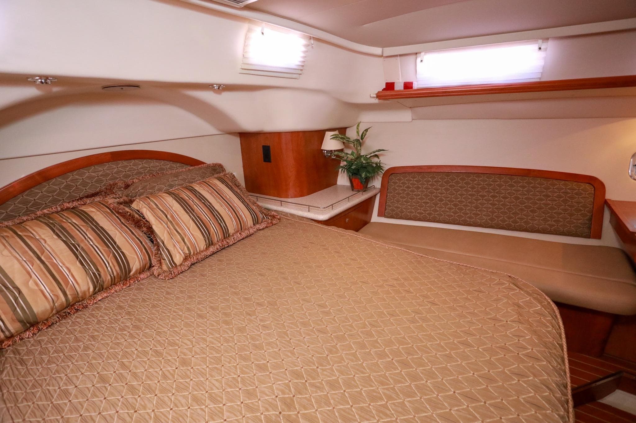 Luxurious cabin interior of 2009 Hunter 45 Center Cockpit yacht with cozy bedding.