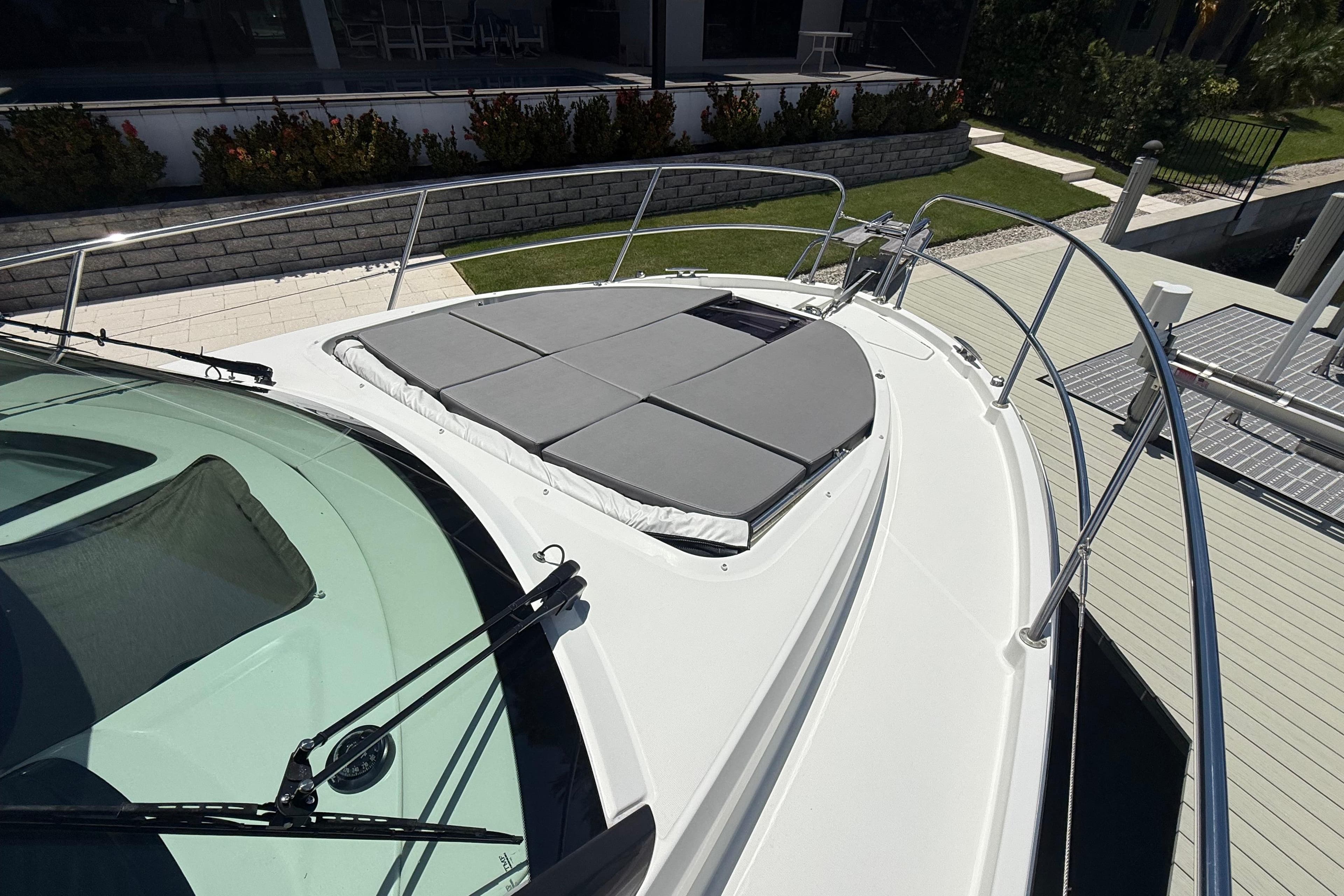 2024 Beneteau Antares 11 boat deck with sunbathing area and sleek design.