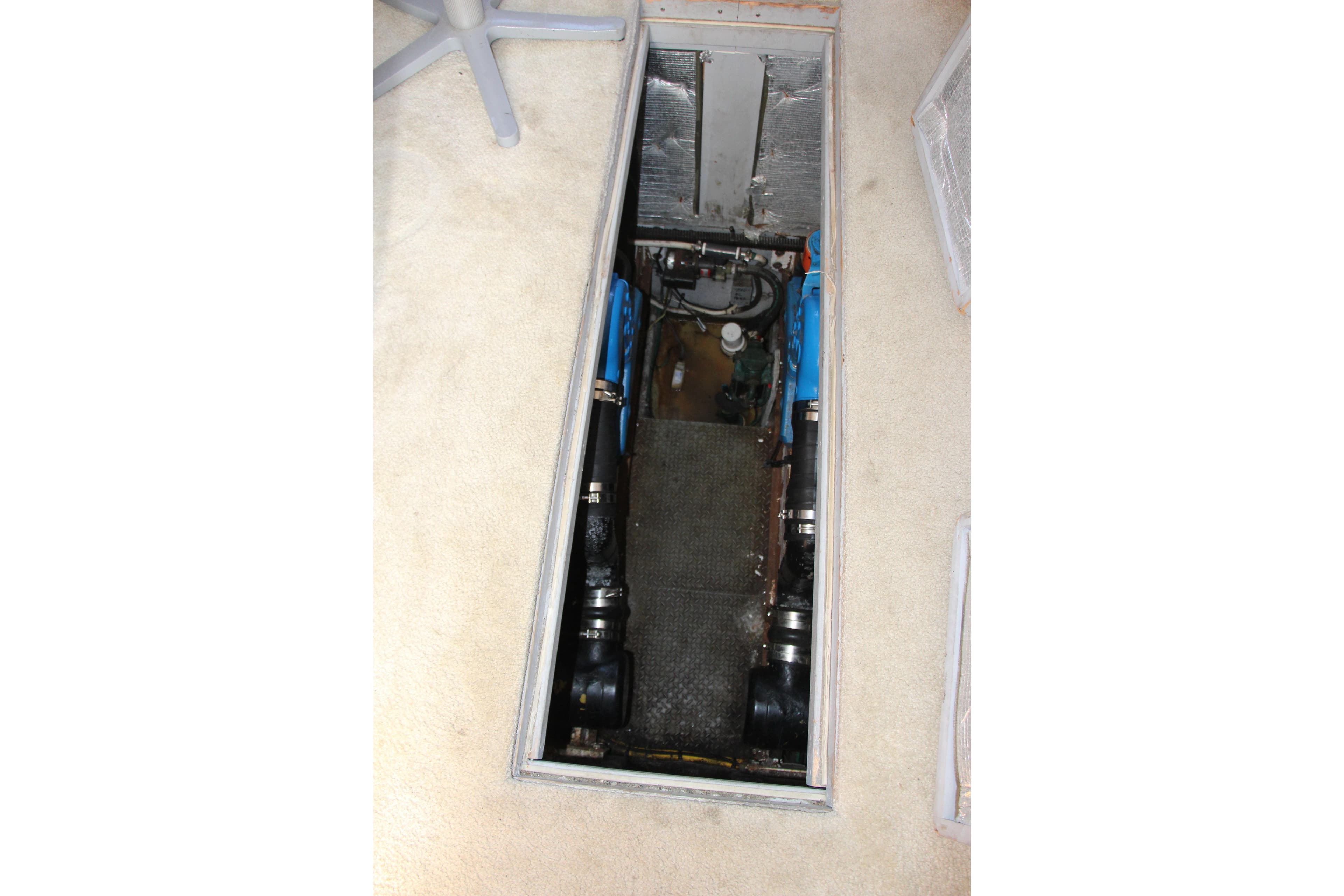 Engine compartment of a 2003 Silverton 38 Convertible boat, showcasing mechanical components.