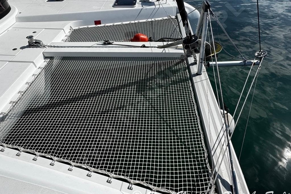 2018 Lagoon 42 catamaran deck with netting over calm water.