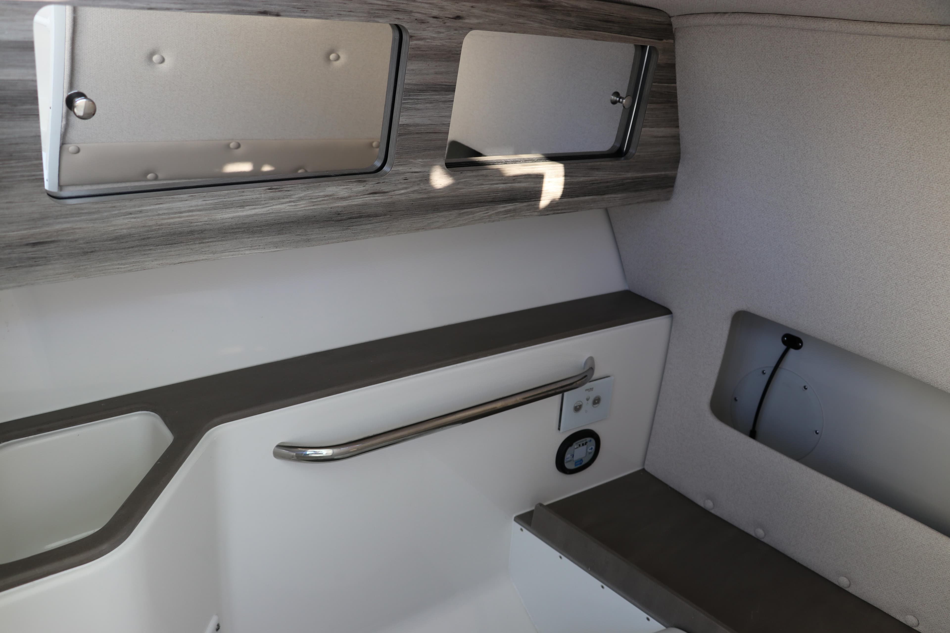 Interior of 2025 Edgewater 248 CX boat, featuring sleek storage and modern design.