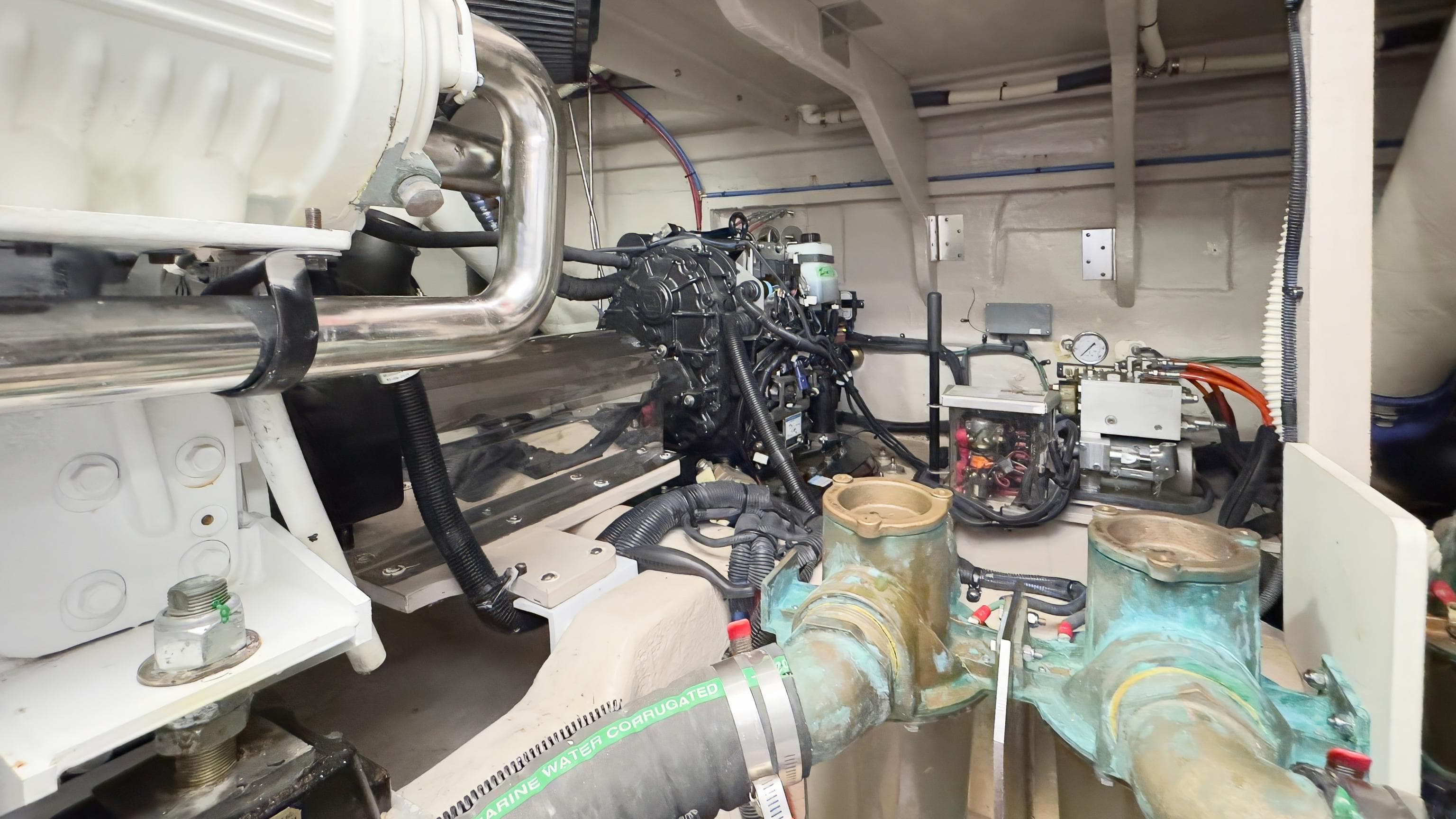 Engine room of 2014 Sea Ray 510 Fly yacht, showcasing mechanical components and piping.