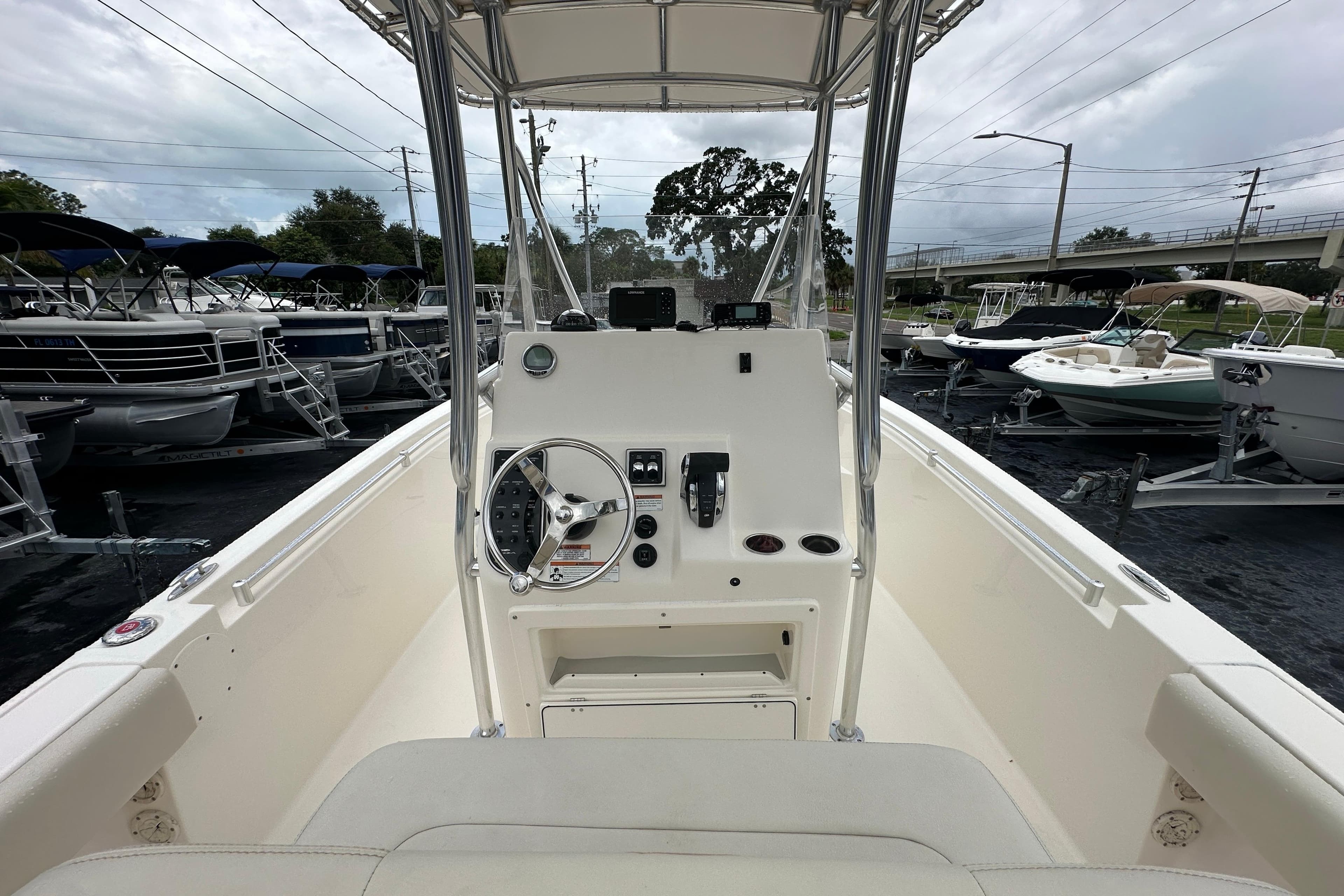 2022 Cobia 237 Center Console boat interior with steering wheel and controls.