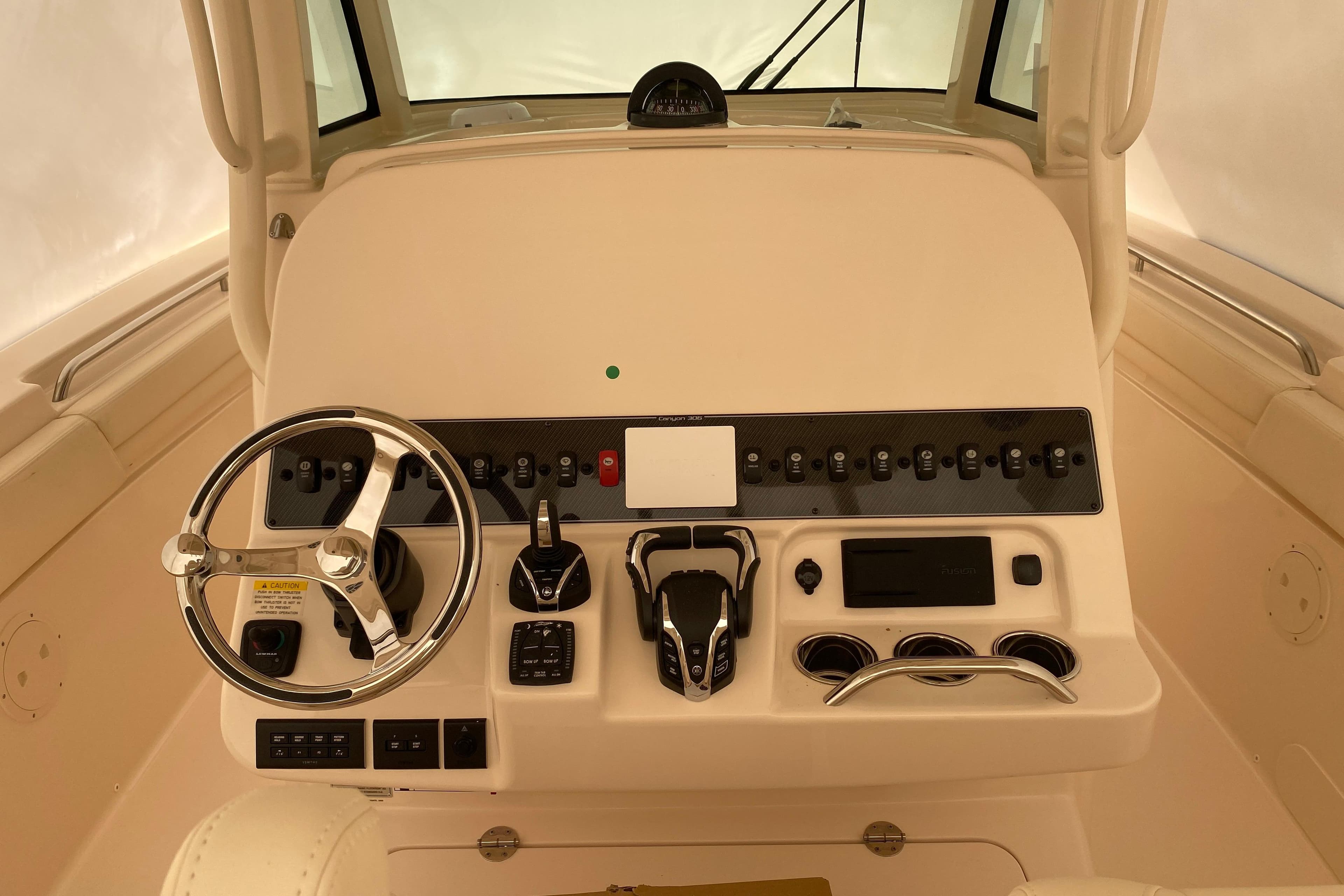 2026 Grady-White Canyon 306 helm with steering wheel and control panel.