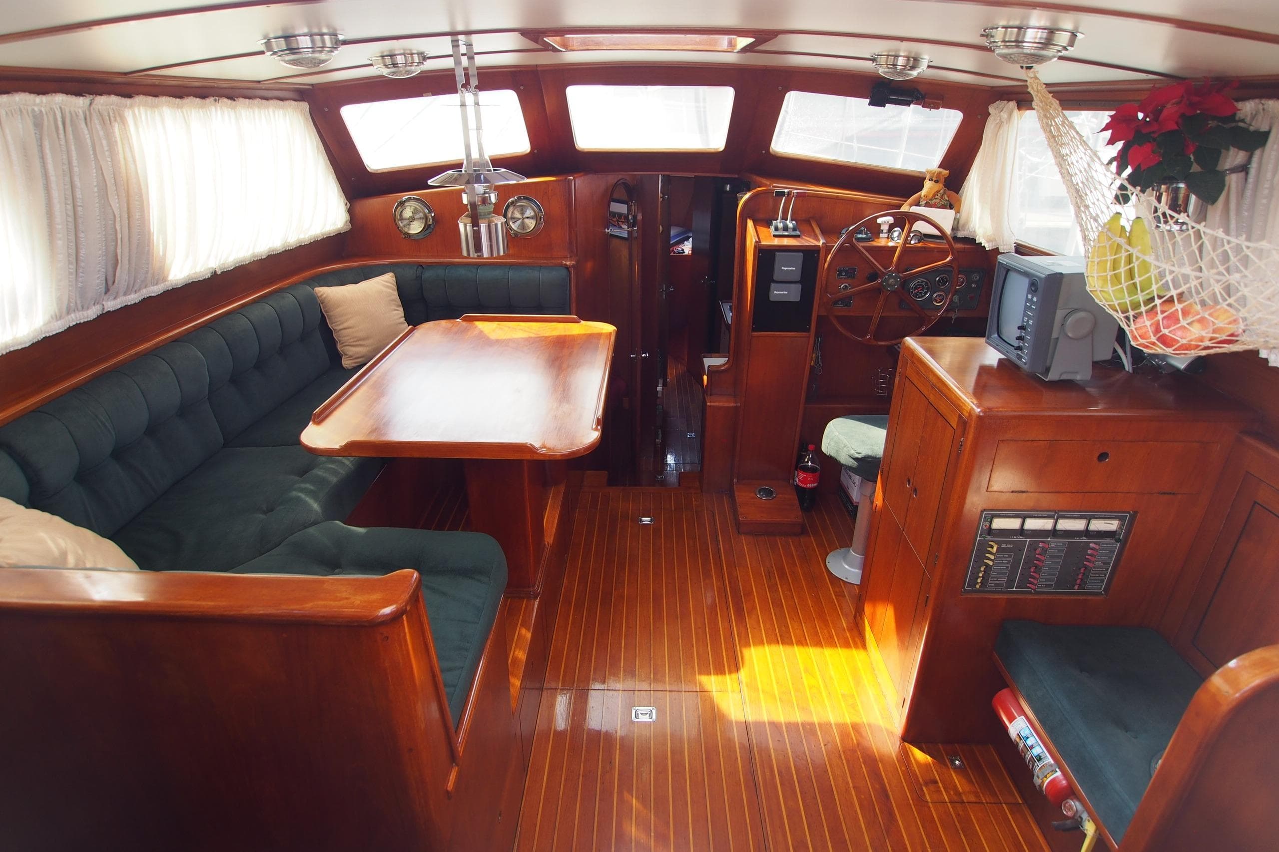 Luxurious 1992 Crescent Custom yacht interior with wood finish, plush seating, and navigation area.