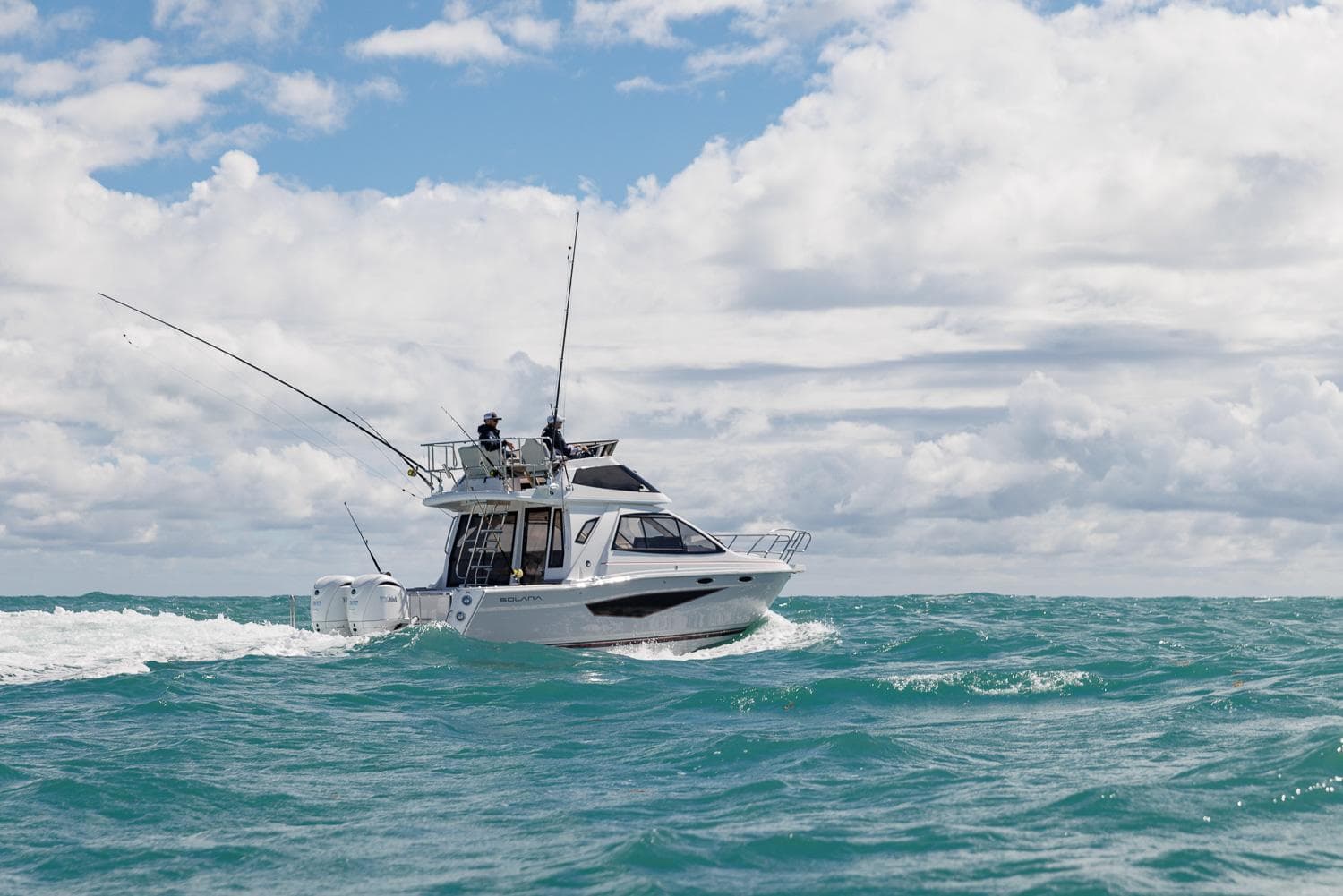 2026 Solara S-310 SB boat cruising on open sea under cloudy sky.
