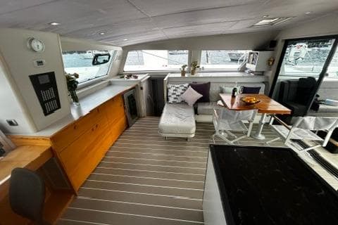Luxurious interior of 2012 Catana 62 yacht with modern furnishings and panoramic windows.