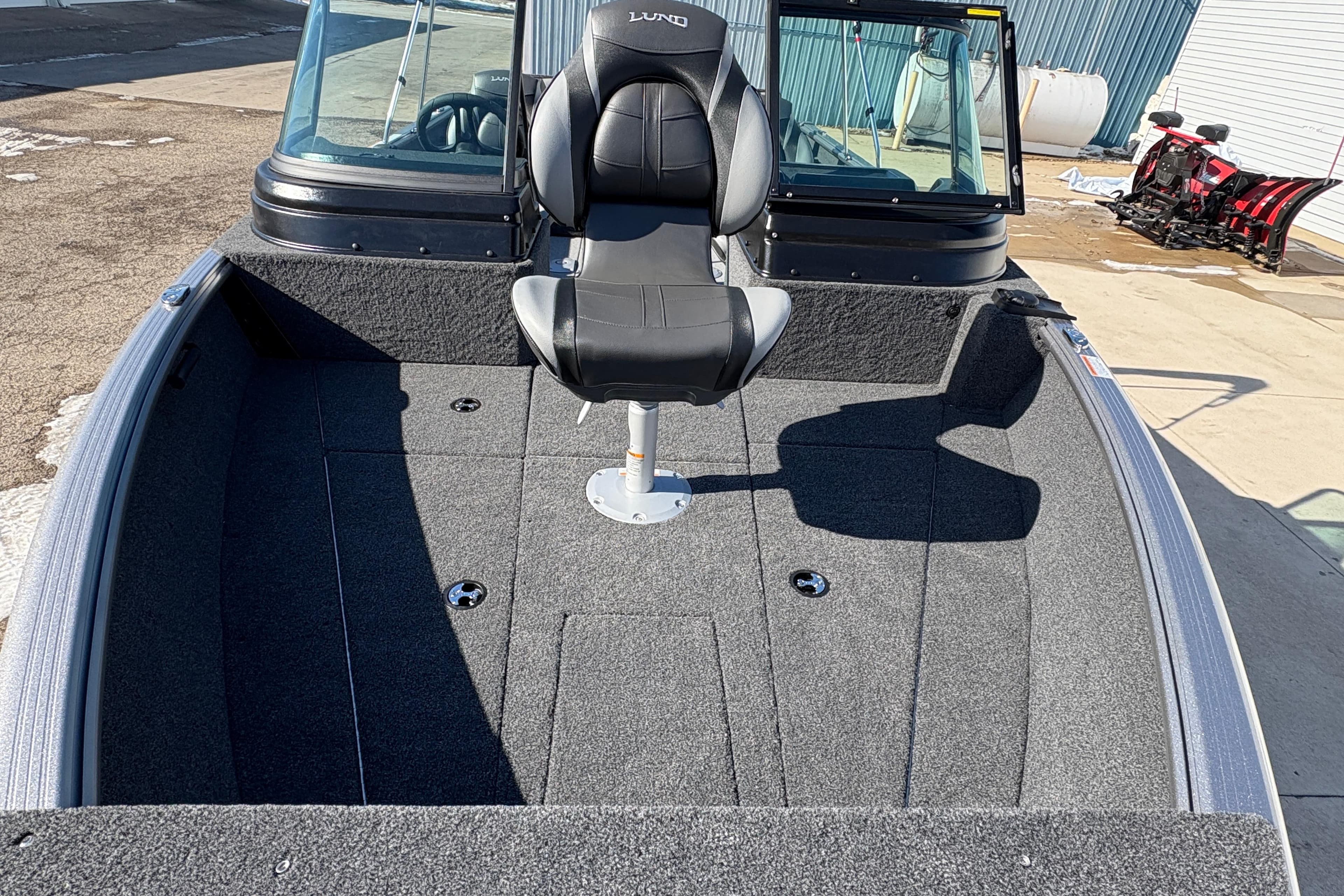 2026 Lund 1875 Impact XS Sport boat interior with seating and windshield.
