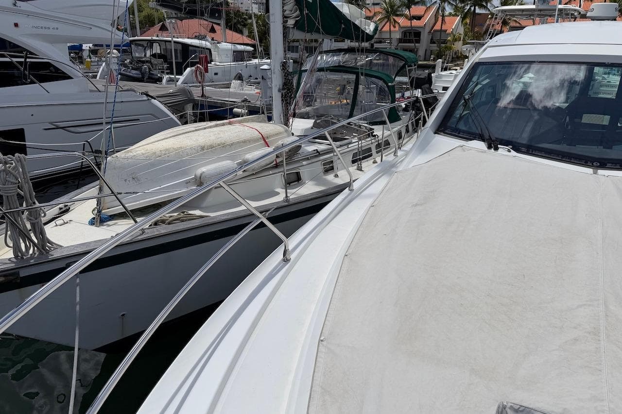 2018 Beneteau Gran Turismo 46 yacht docked at marina, surrounded by other boats.