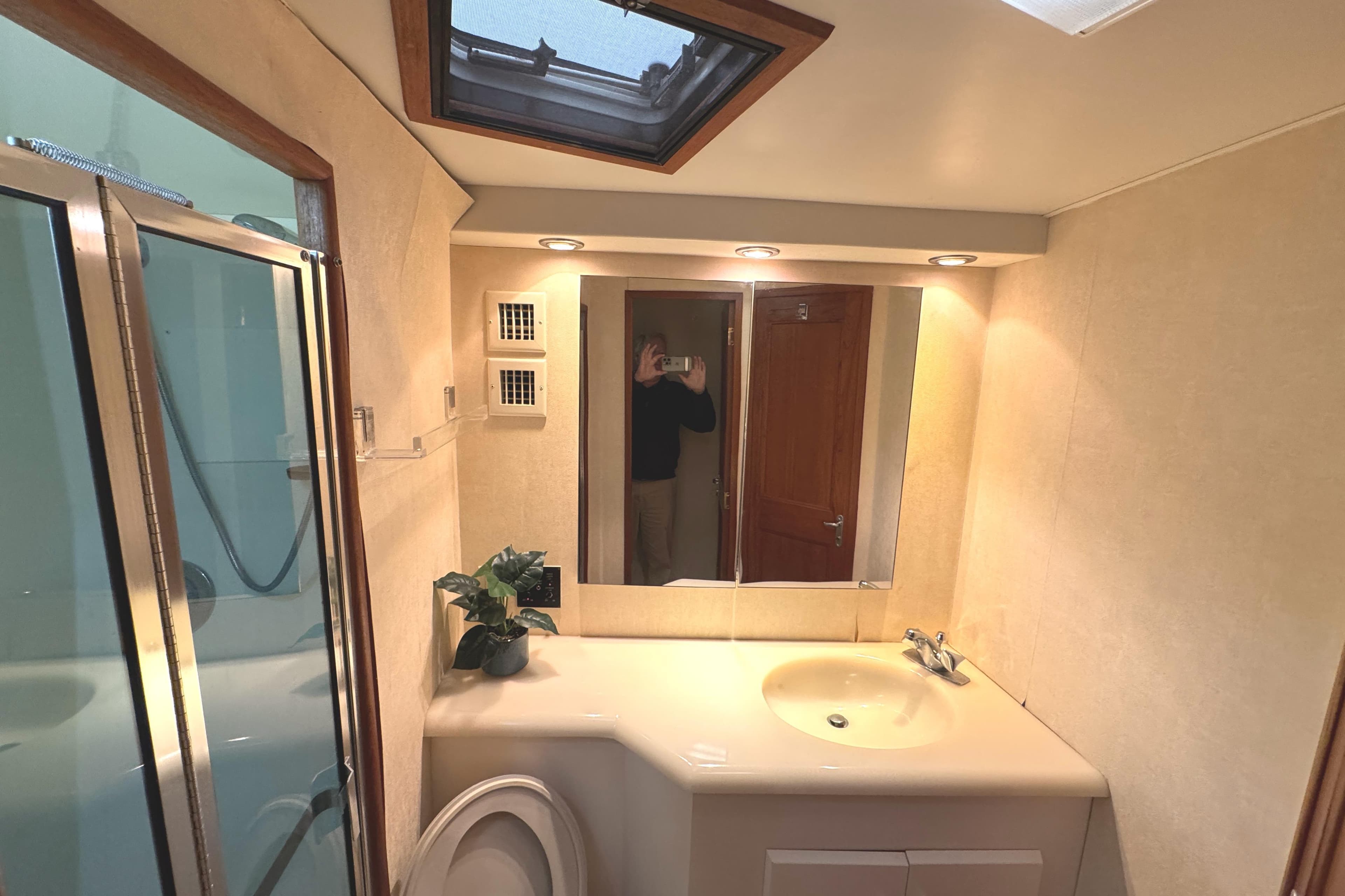 Bathroom interior of 1991 Viking 53 Convertible yacht with shower and skylight.