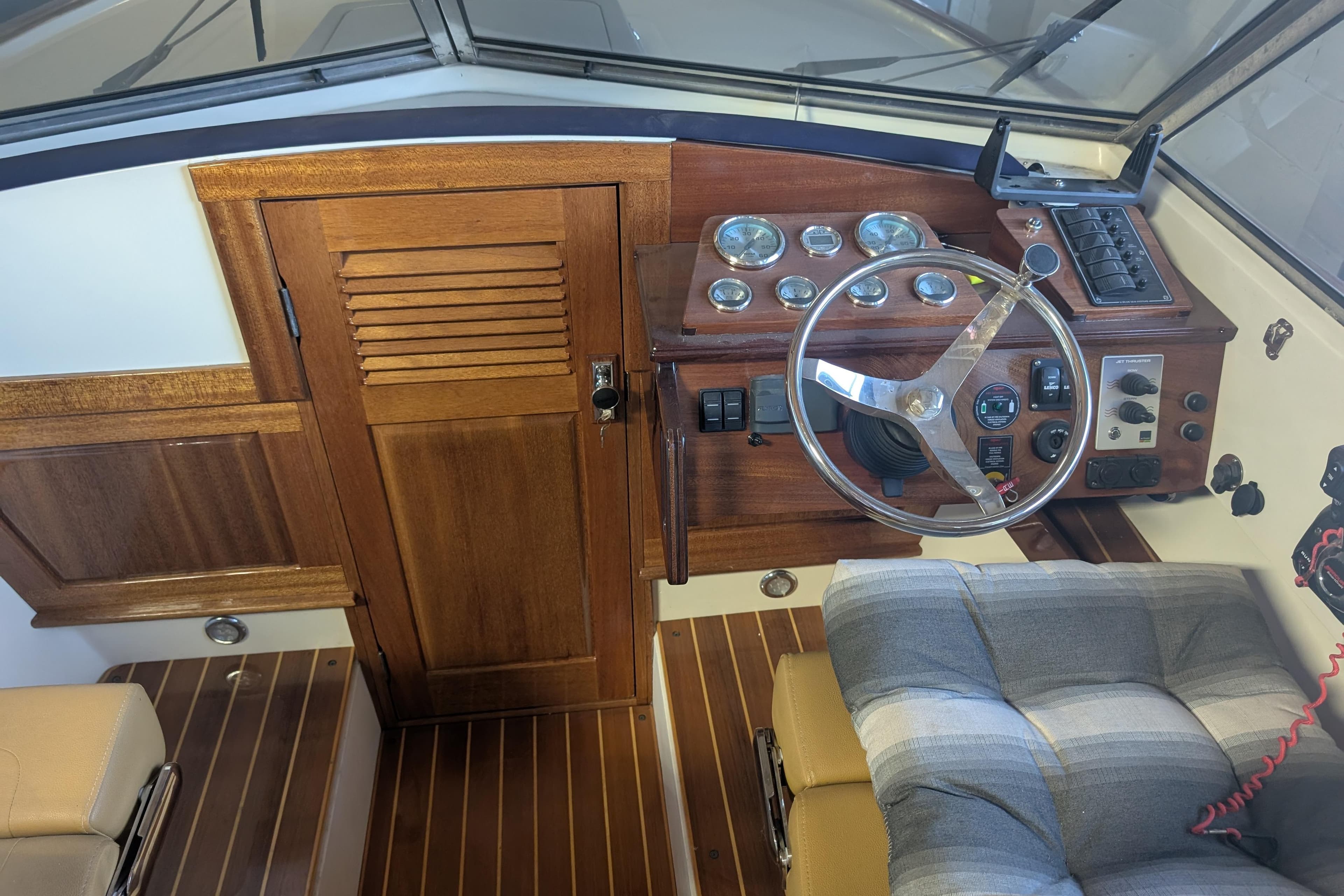 1973 Lyman Islander boat interior with wooden dashboard and steering wheel.