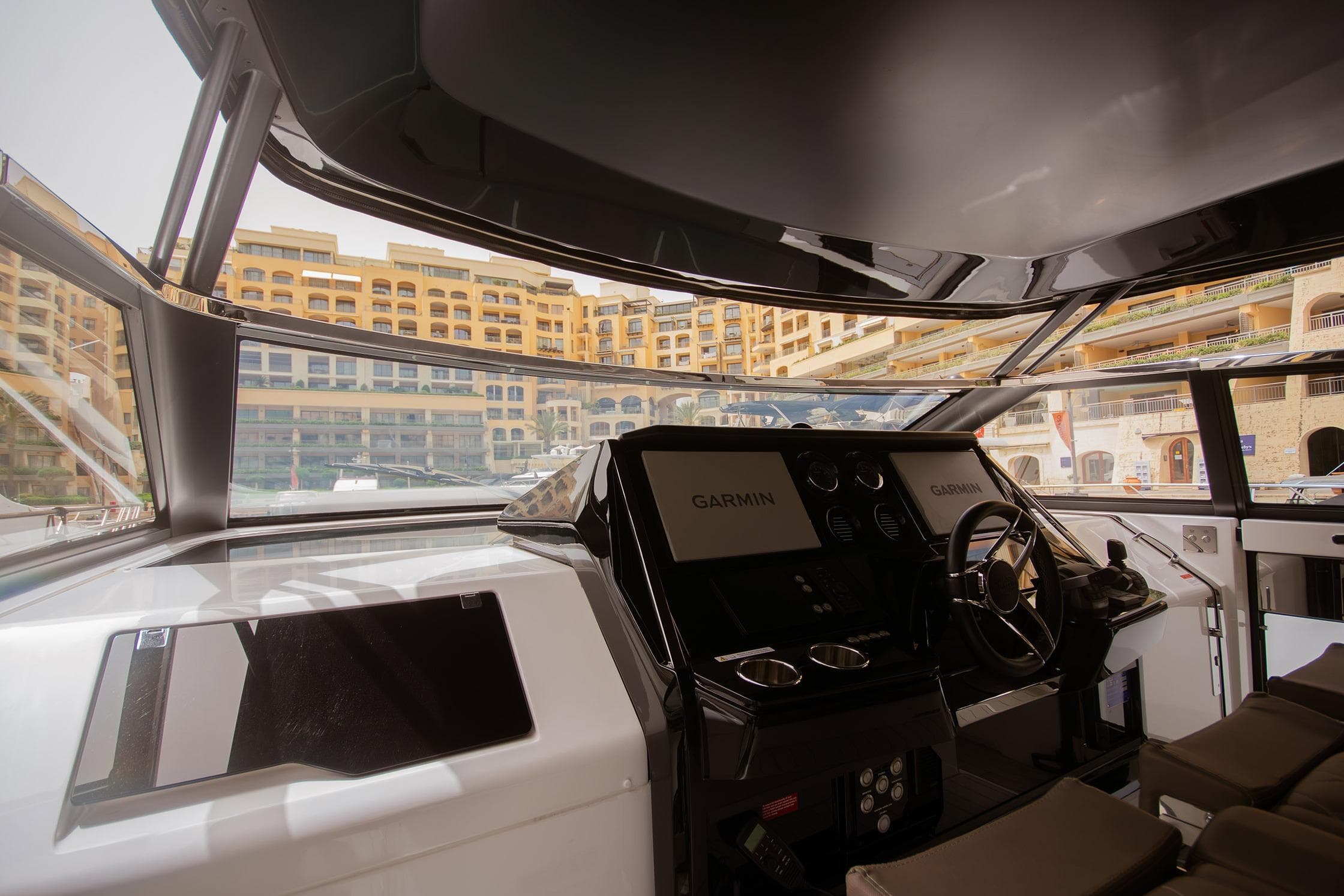 Interior view of 2024 Sunseeker Superhawk 55 yacht cockpit with Garmin navigation system.