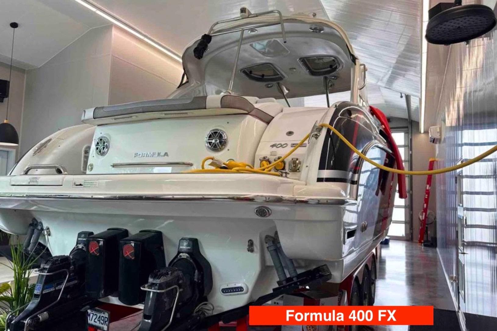 2015 Formula 400 FX boat in a modern indoor storage facility.