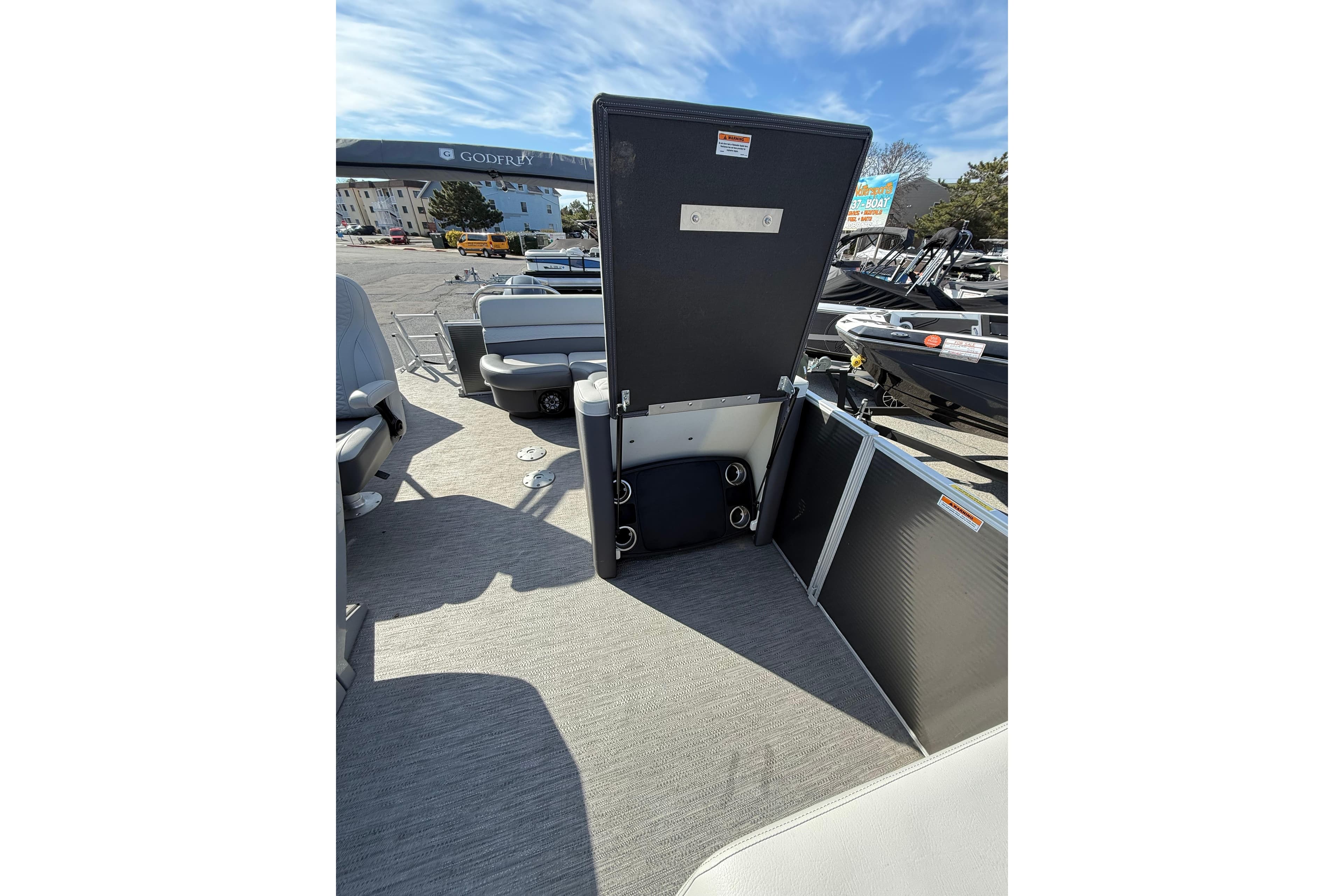 2021 Godfrey Monaco 215 C pontoon boat interior with open storage compartment.