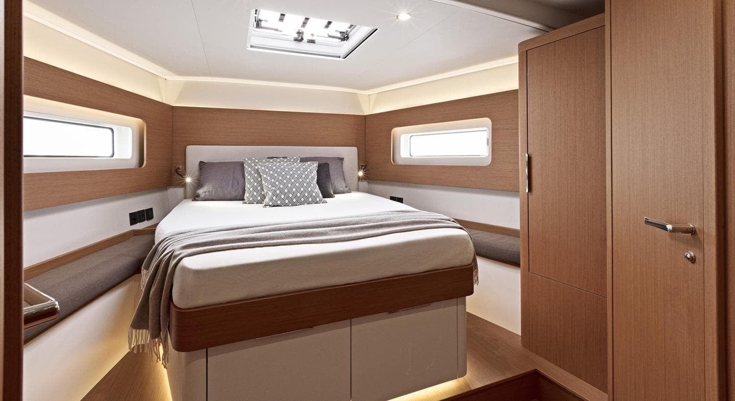 Luxurious bedroom interior of 2025 Beneteau First 53 yacht with modern design.