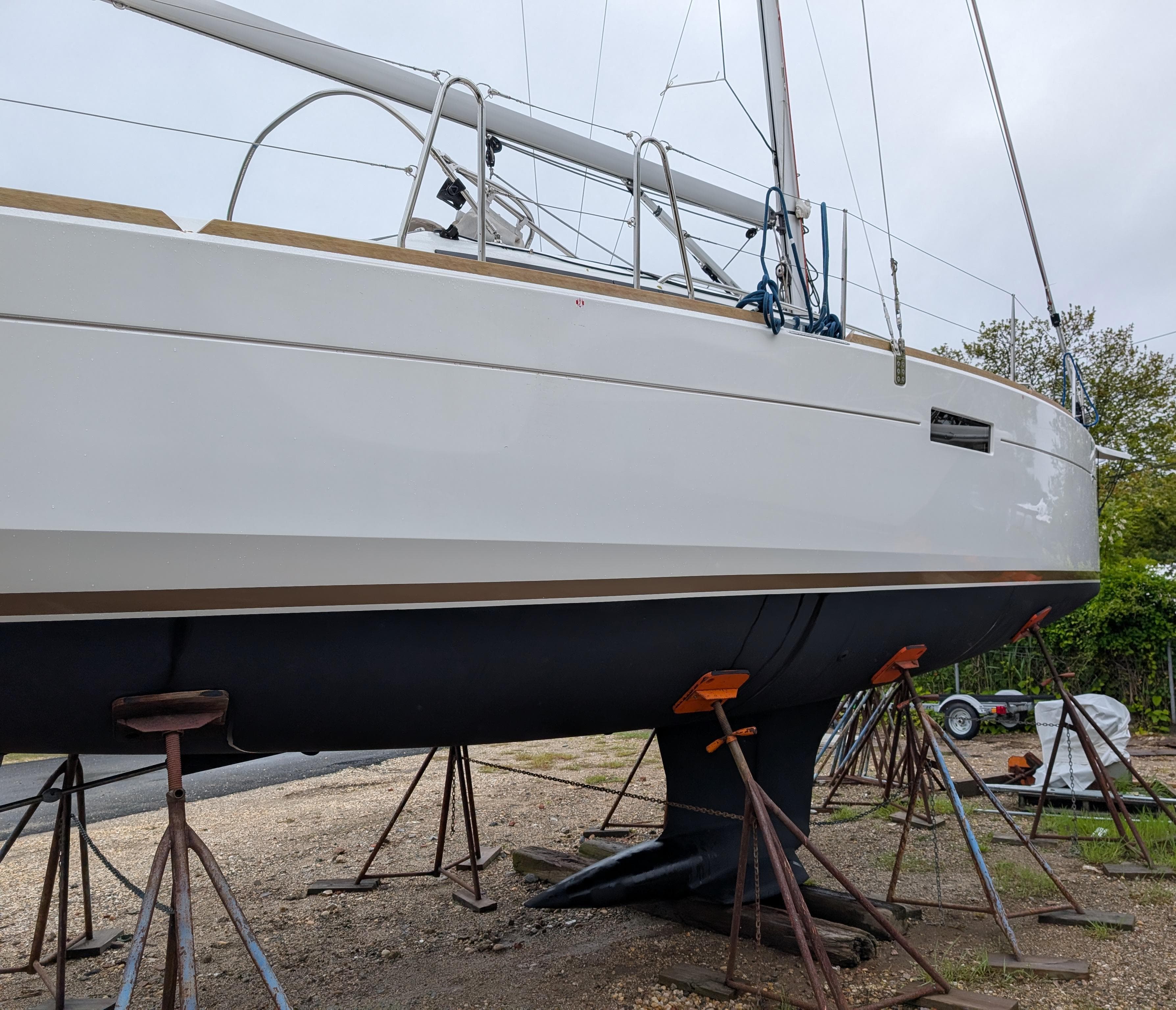 2021 Jeanneau Sun Odyssey 349 sailboat on stands, side view.
