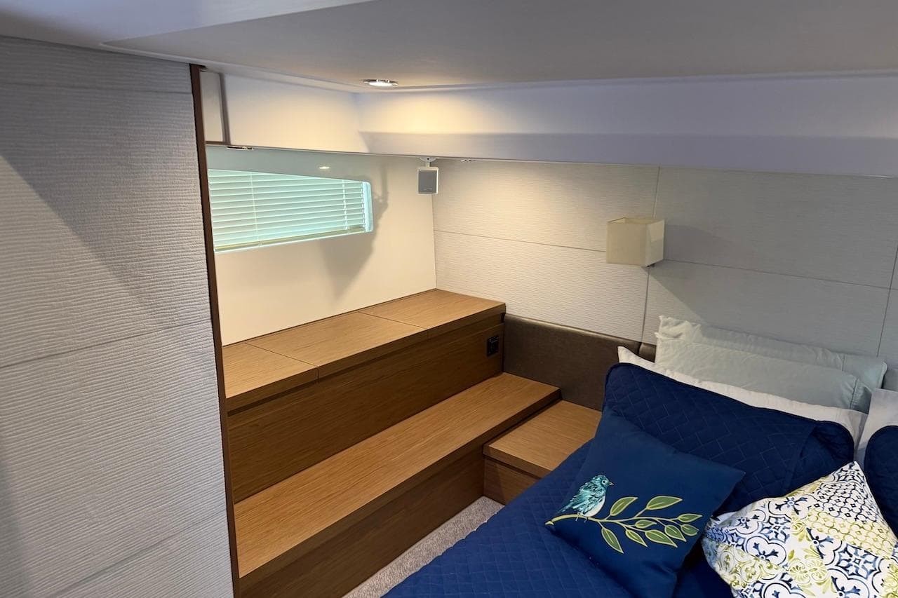Interior cabin of 2018 Beneteau Gran Turismo 46 yacht, featuring cozy bedding and modern design.