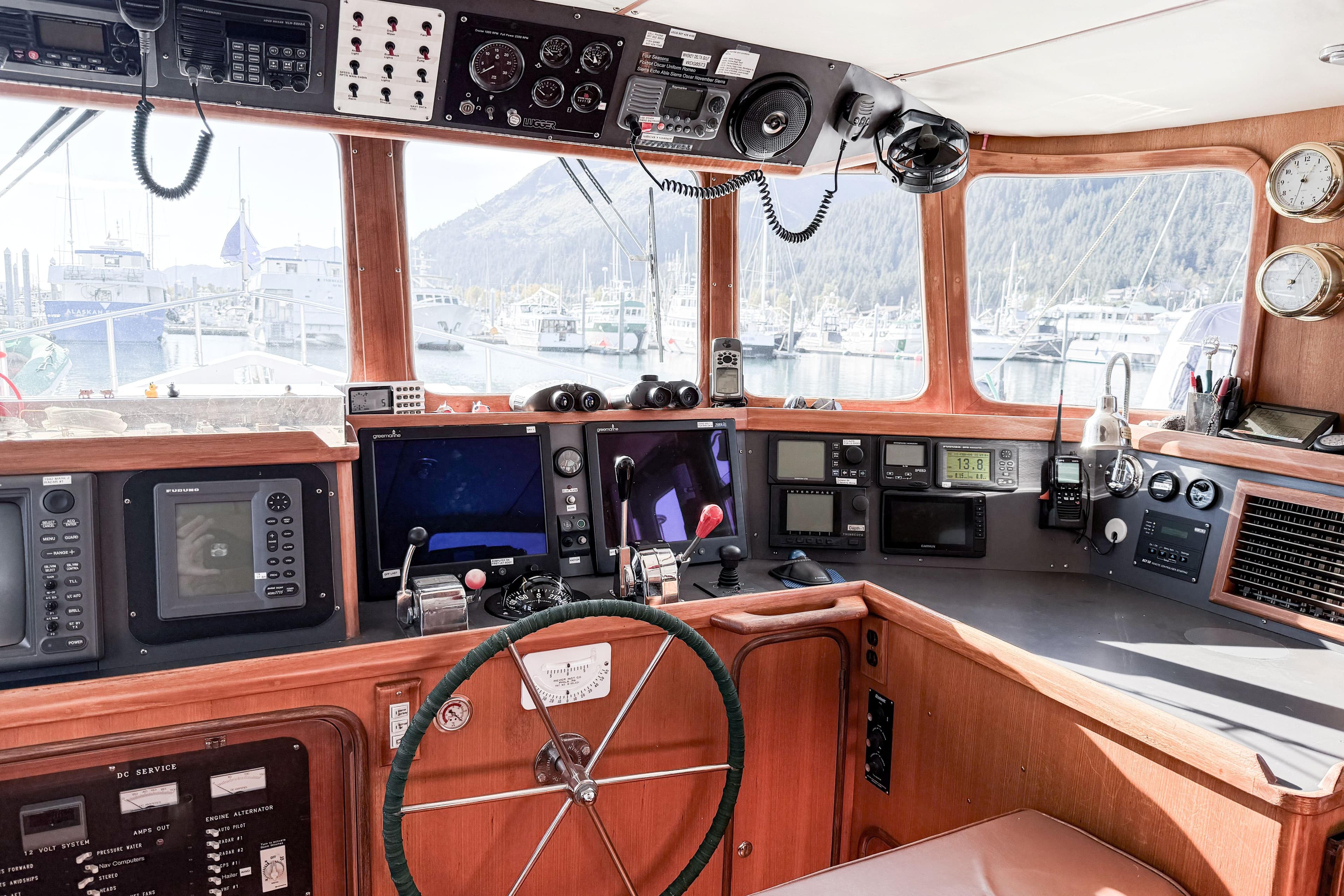 Pilothouse of 2001 Nordhavn 46 yacht with navigation equipment and scenic marina view.