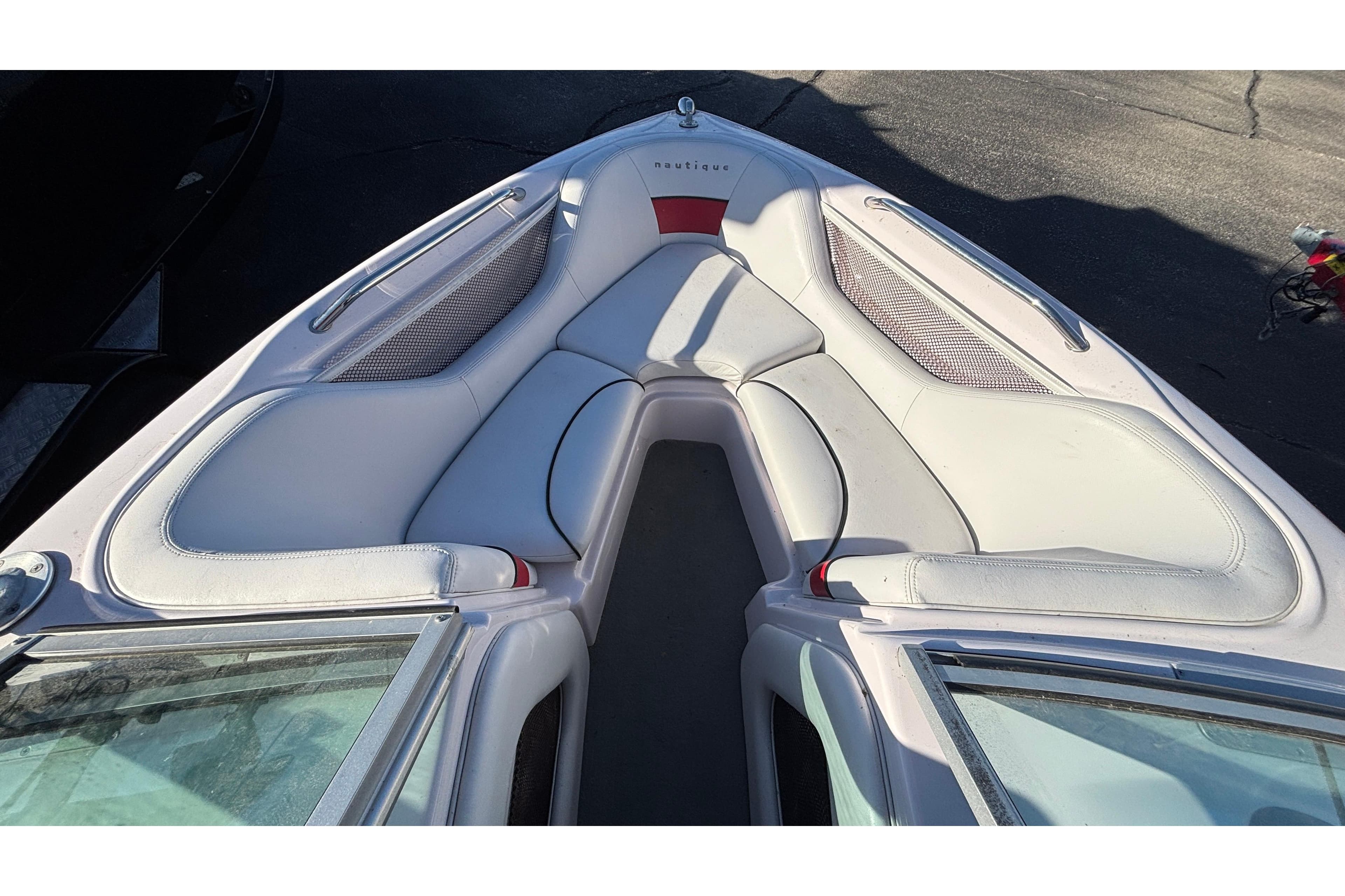 2006 Nautique Ski Nautique 206 boat interior with white seating and red accents.