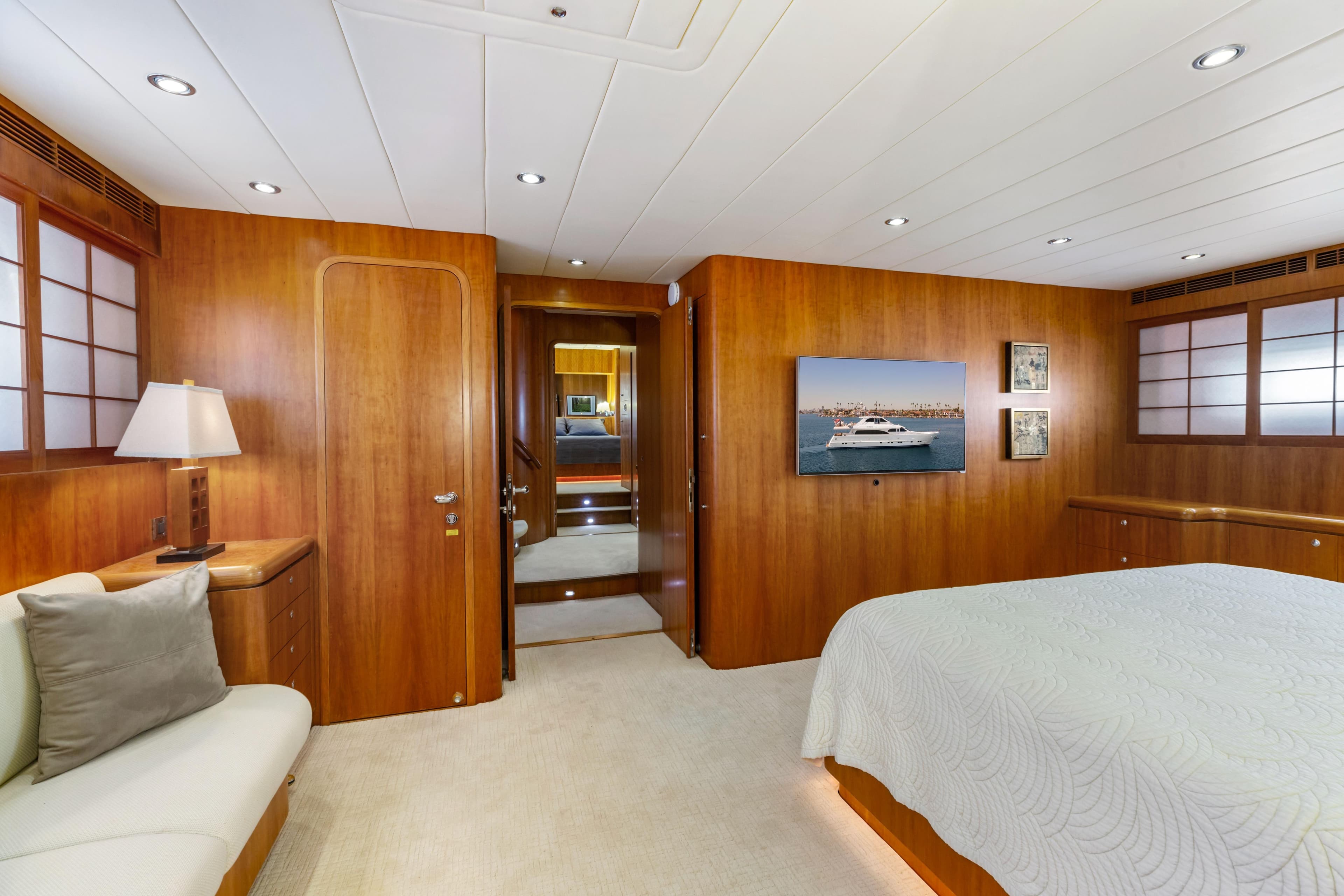 Luxurious yacht bedroom with wooden paneling, modern lighting, and elegant decor, 2005 Custom model.