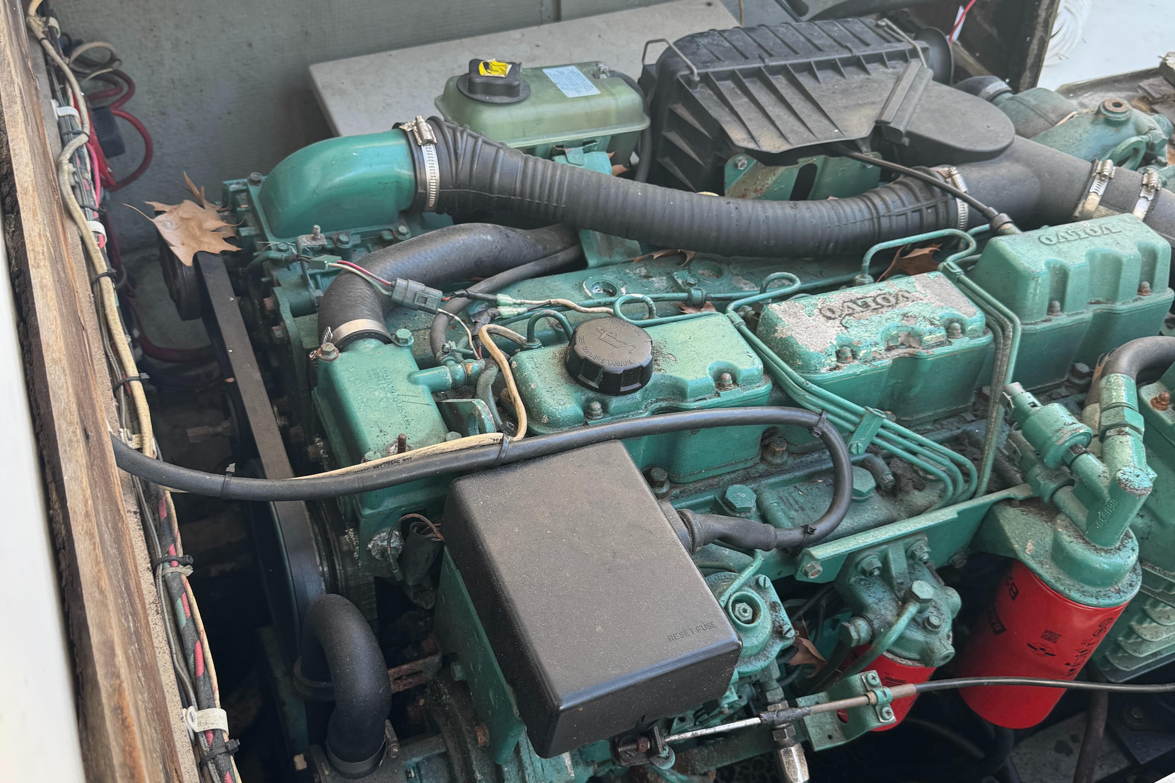 Engine compartment of a 1974 Bertram 31 Flybridge boat, showcasing mechanical components.