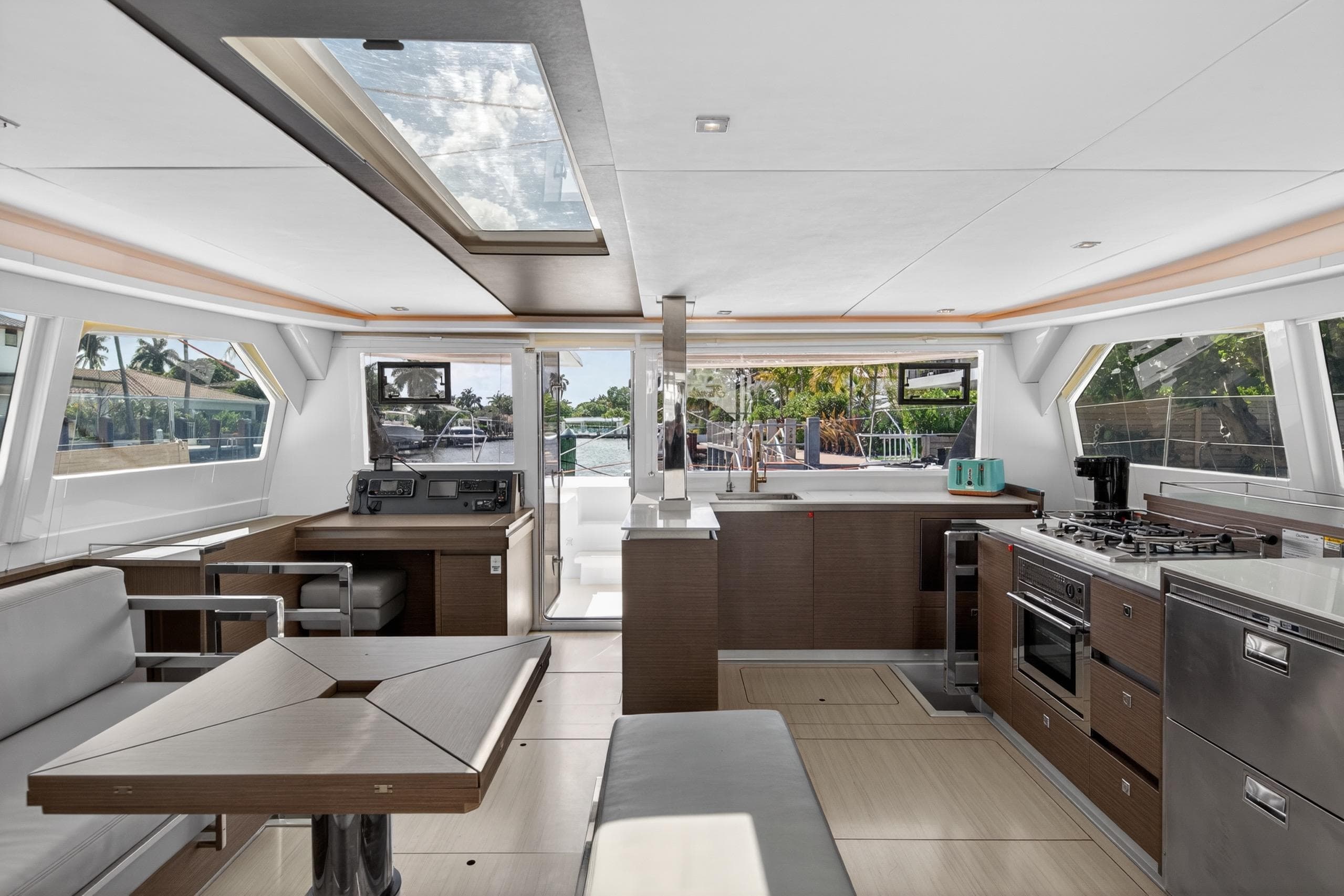 Luxurious interior of a 2022 Leopard 50 yacht featuring modern kitchen and seating area.