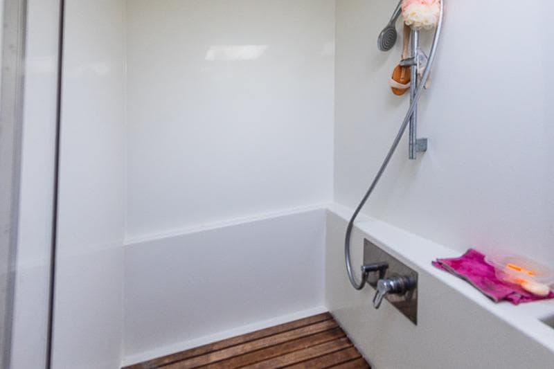 Shower area in 2017 Lagoon 52 S yacht with wooden floor and modern fixtures.