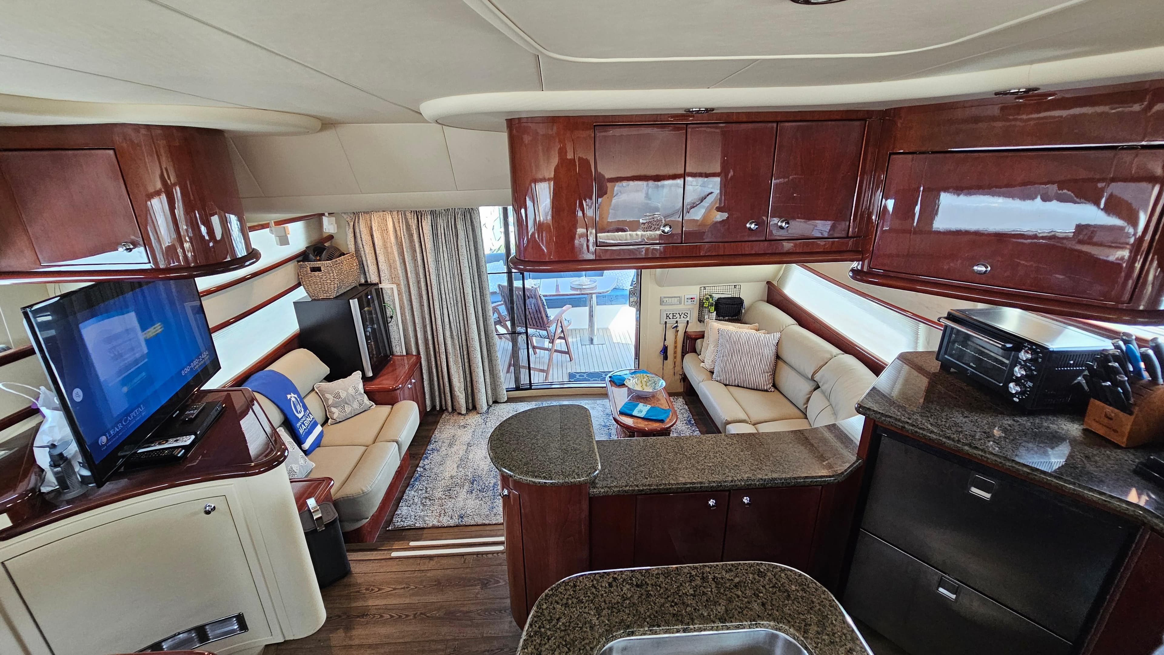 Luxurious interior of 2005 Neptunus 56 Flybridge yacht with elegant wood finishes.