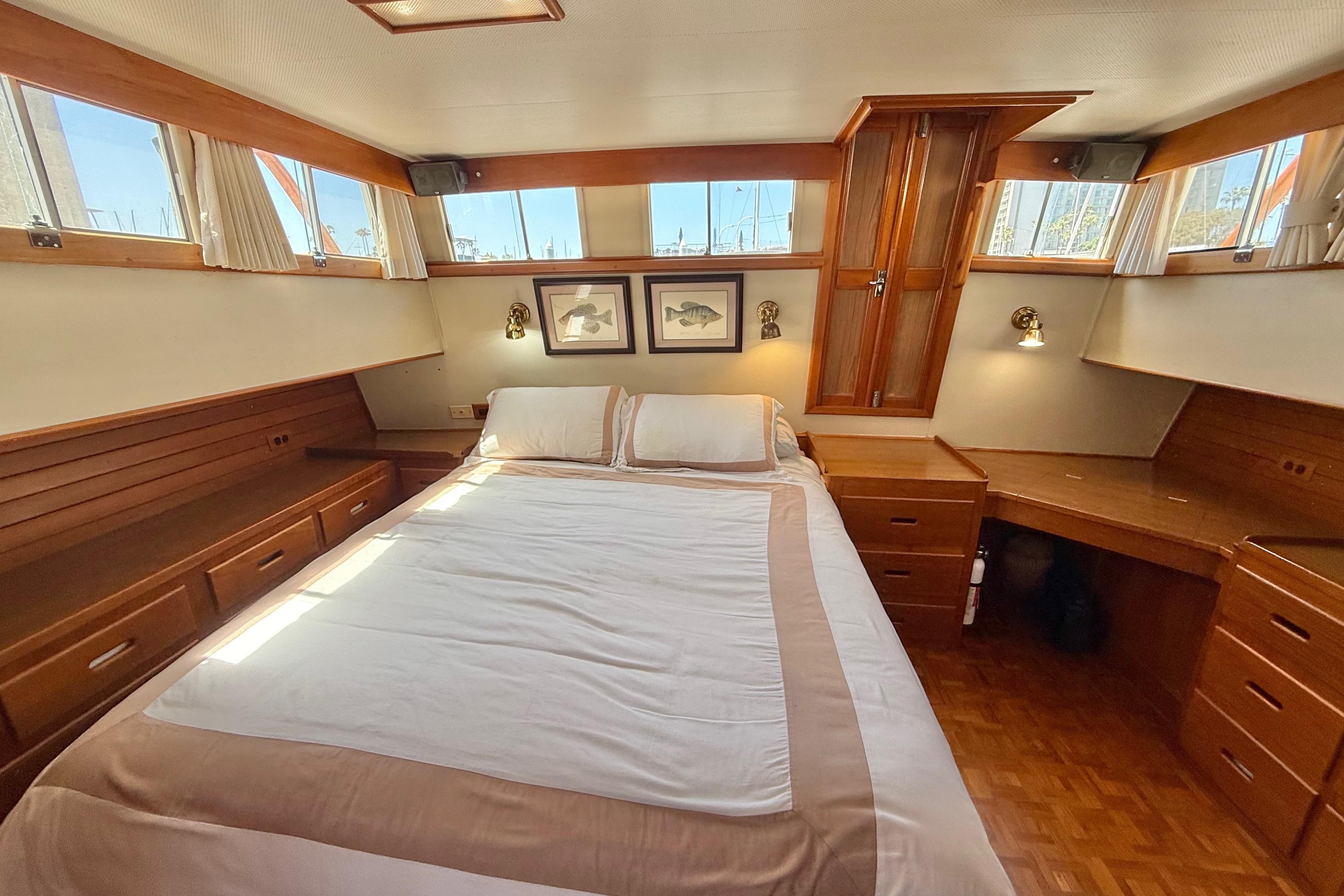 Luxurious 1992 Grand Banks 46 Classic yacht bedroom with elegant wood furnishings.
