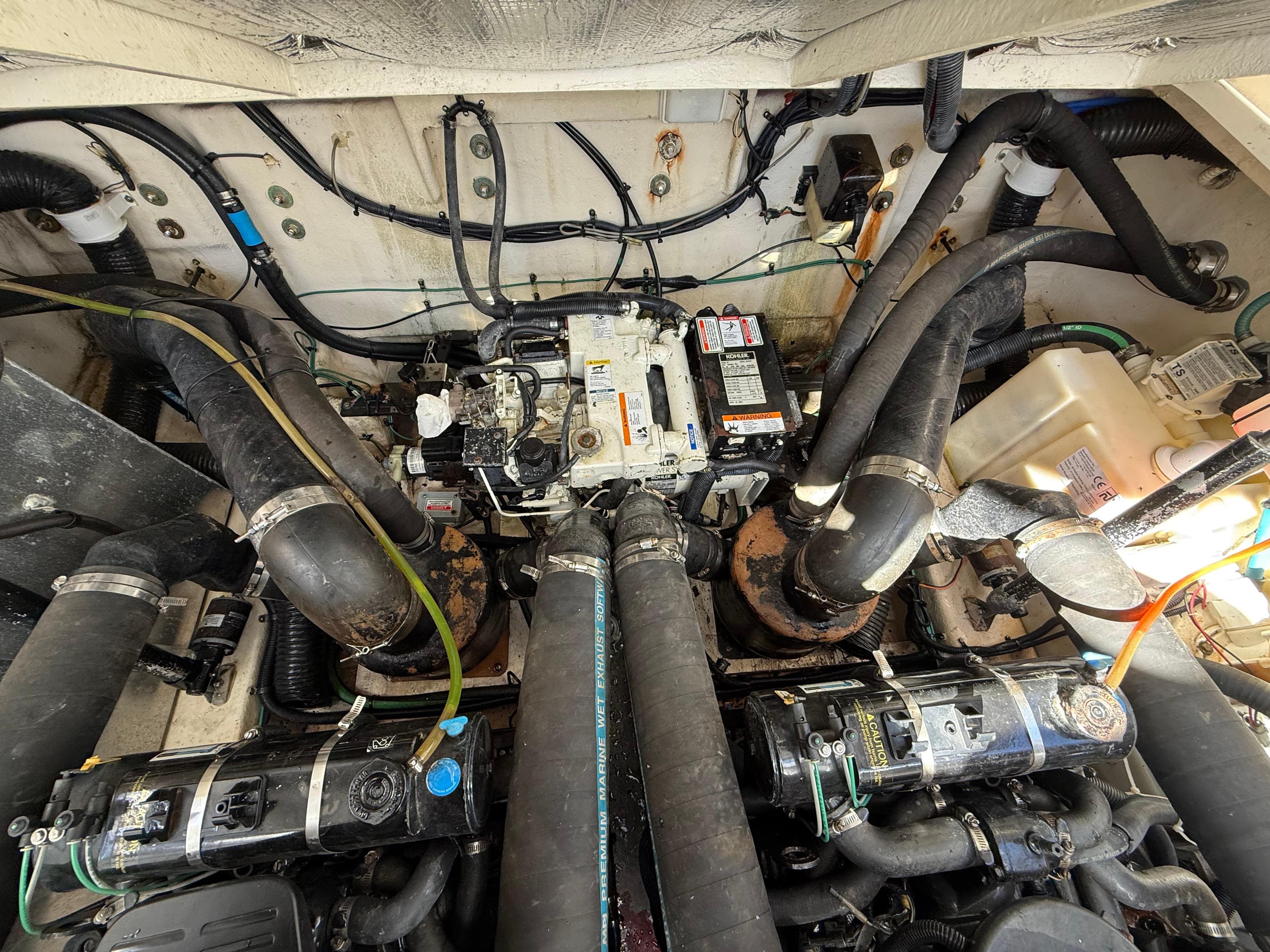 Engine compartment of a 2006 Sea Ray 320 Sundancer boat, showcasing mechanical components.