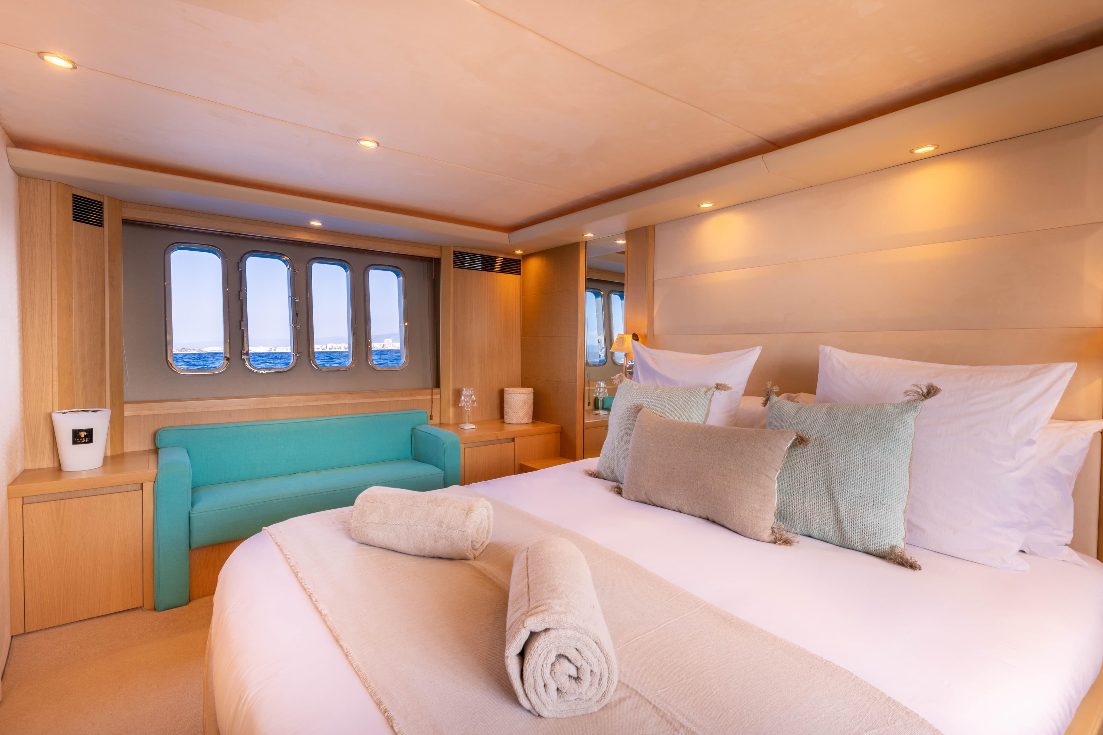 Luxurious 2008 Princess V70 yacht bedroom with ocean view, elegant decor, and cozy bedding.