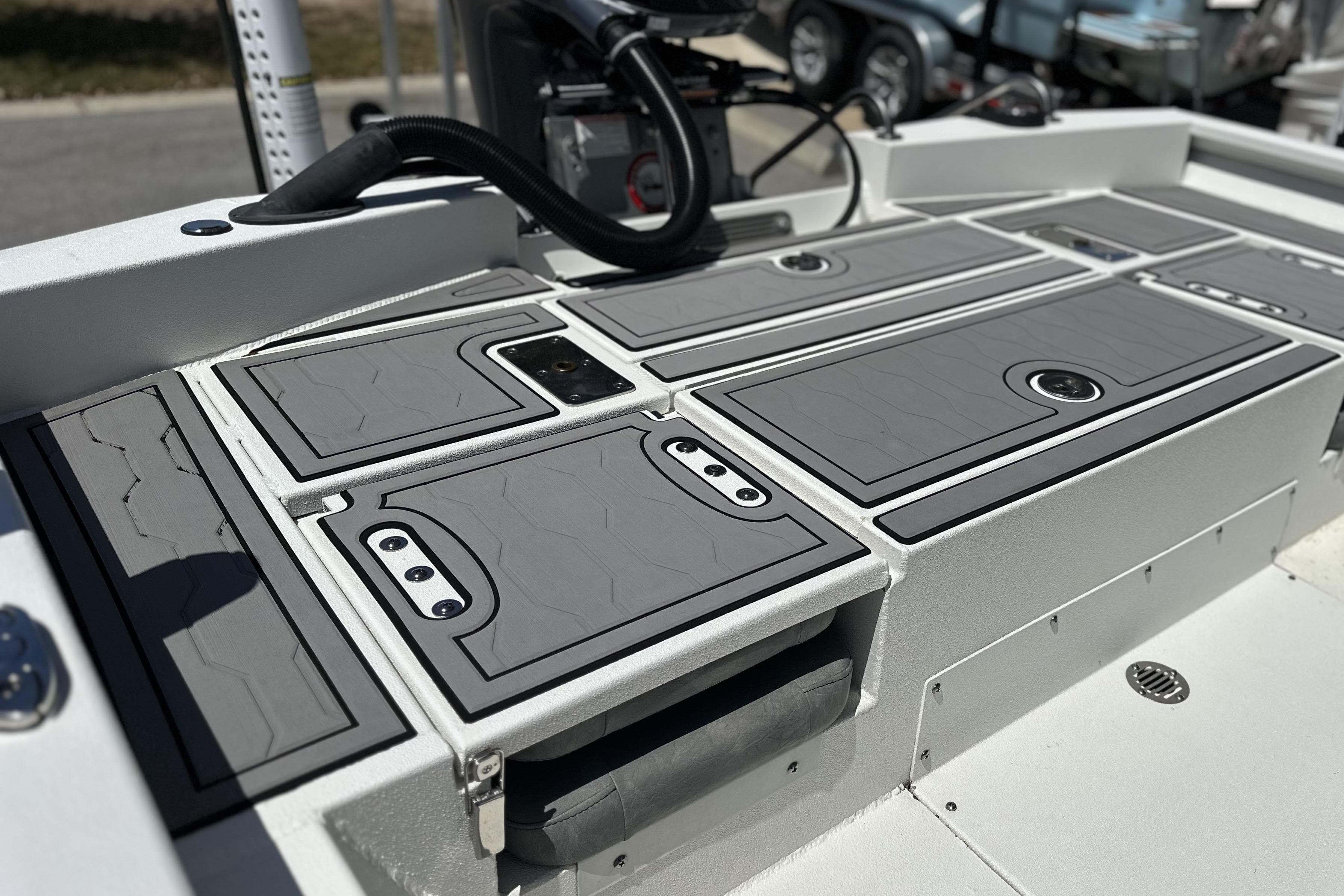2024 Avid 23 Mag boat deck with sleek gray storage compartments.