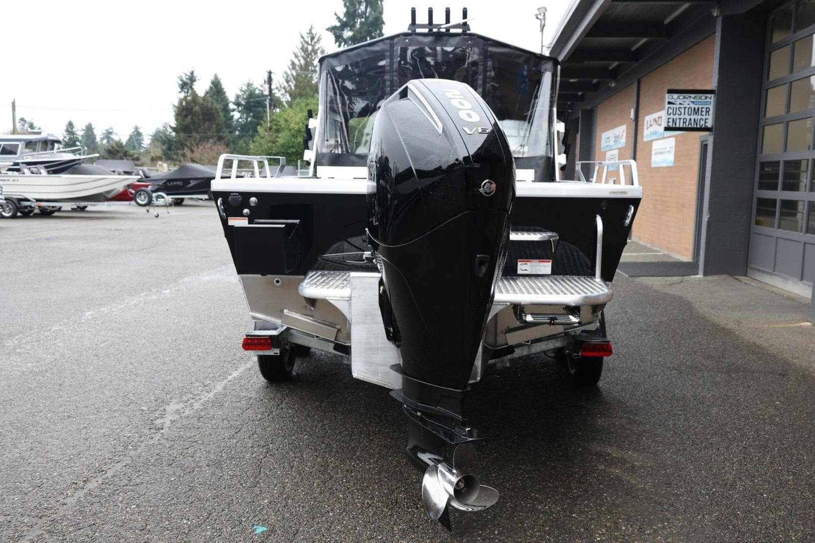 2026 Thunder Jet 210 Luxor Limited boat with powerful outboard motor in a dealership lot.