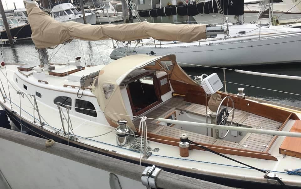 1967 LeComte Northeast 38 sailboat docked in marina, featuring classic design and wooden accents.