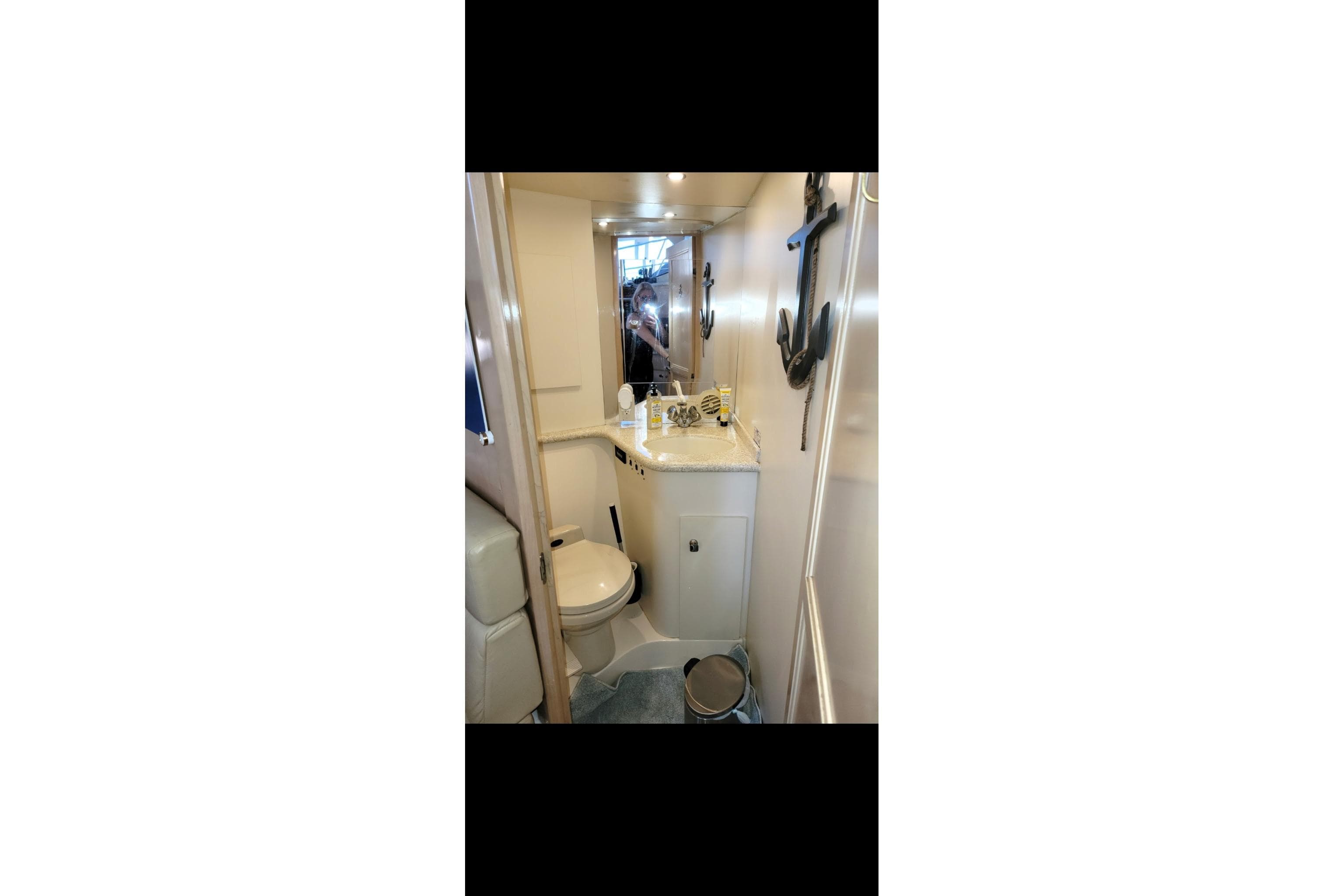 Bathroom interior of 2000 Carver 406 Aft Cabin Motor Yacht, featuring compact design and nautical decor.