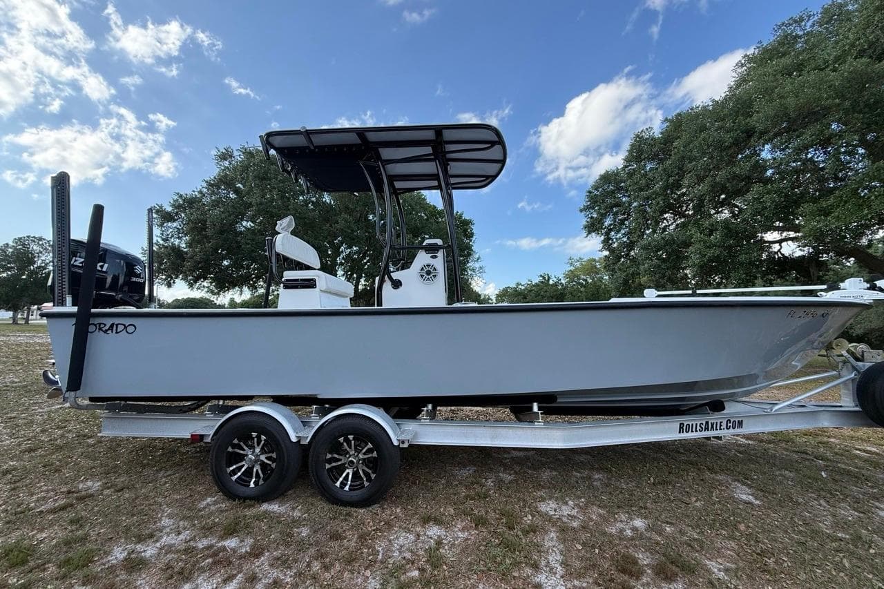 2017 Dorado 25 SE boat on trailer, parked outdoors under a blue sky.