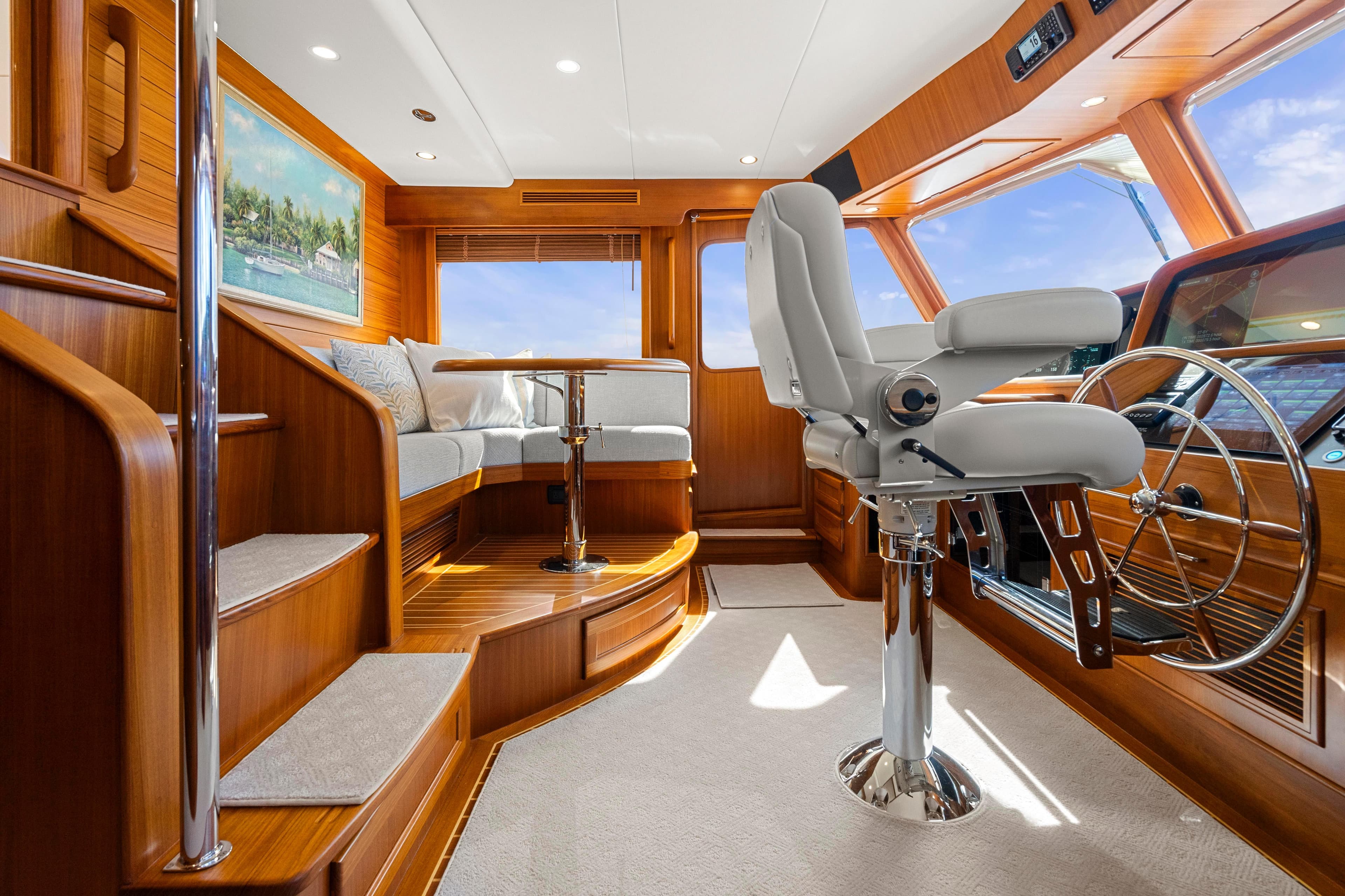 Luxurious interior of 2023 Fleming 65 yacht with plush seating and modern helm.
