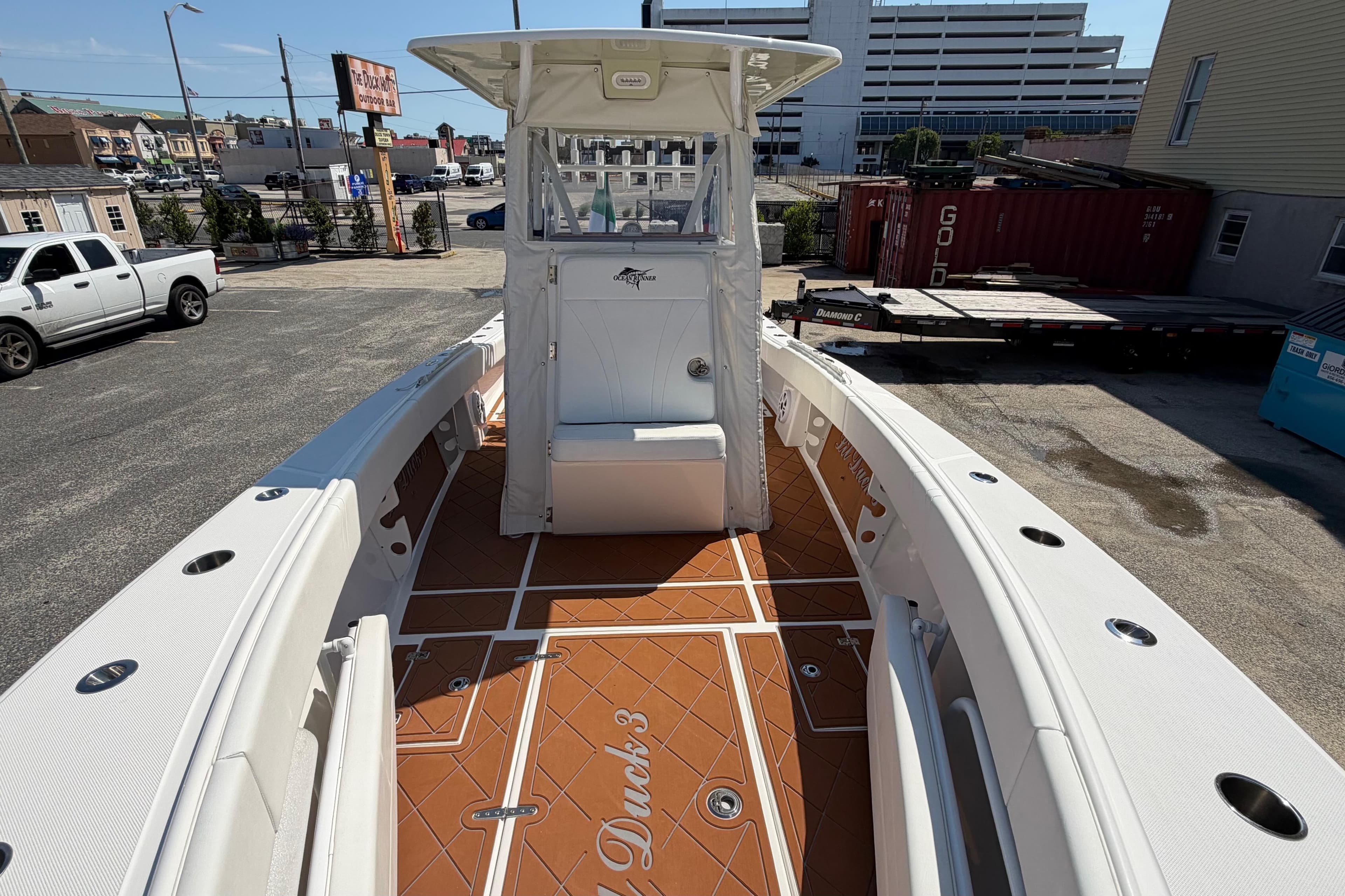 2023 Ocean Runner 2 boat with spacious deck and modern design in urban setting.