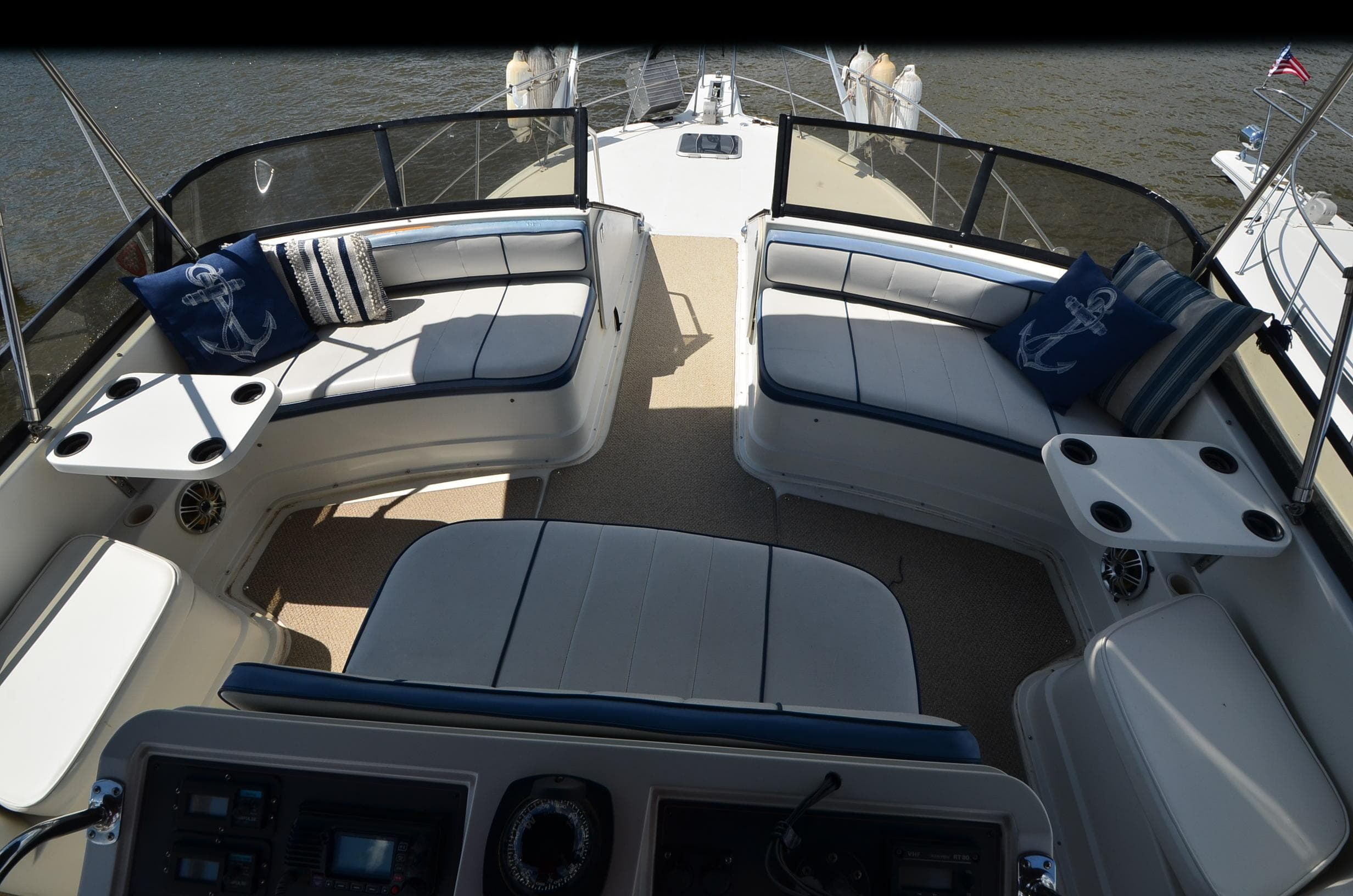1989 Carver Santego 3867 boat interior with cushioned seating and nautical-themed pillows.